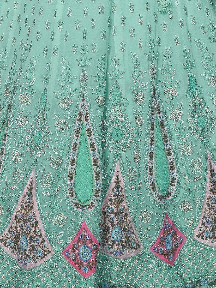Mint green lehenga with intricate floral embroidery and pink-blue embellished motifs, perfect for Indian ethnic wear.