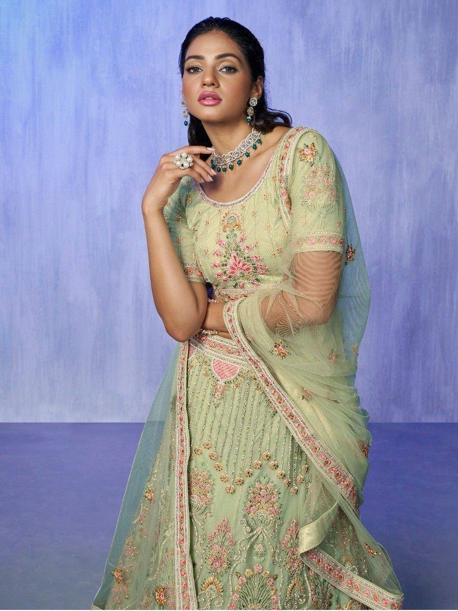Mint green embroidered lehenga choli with floral motifs and sheer dupatta, perfect for Indian ethnic occasions.