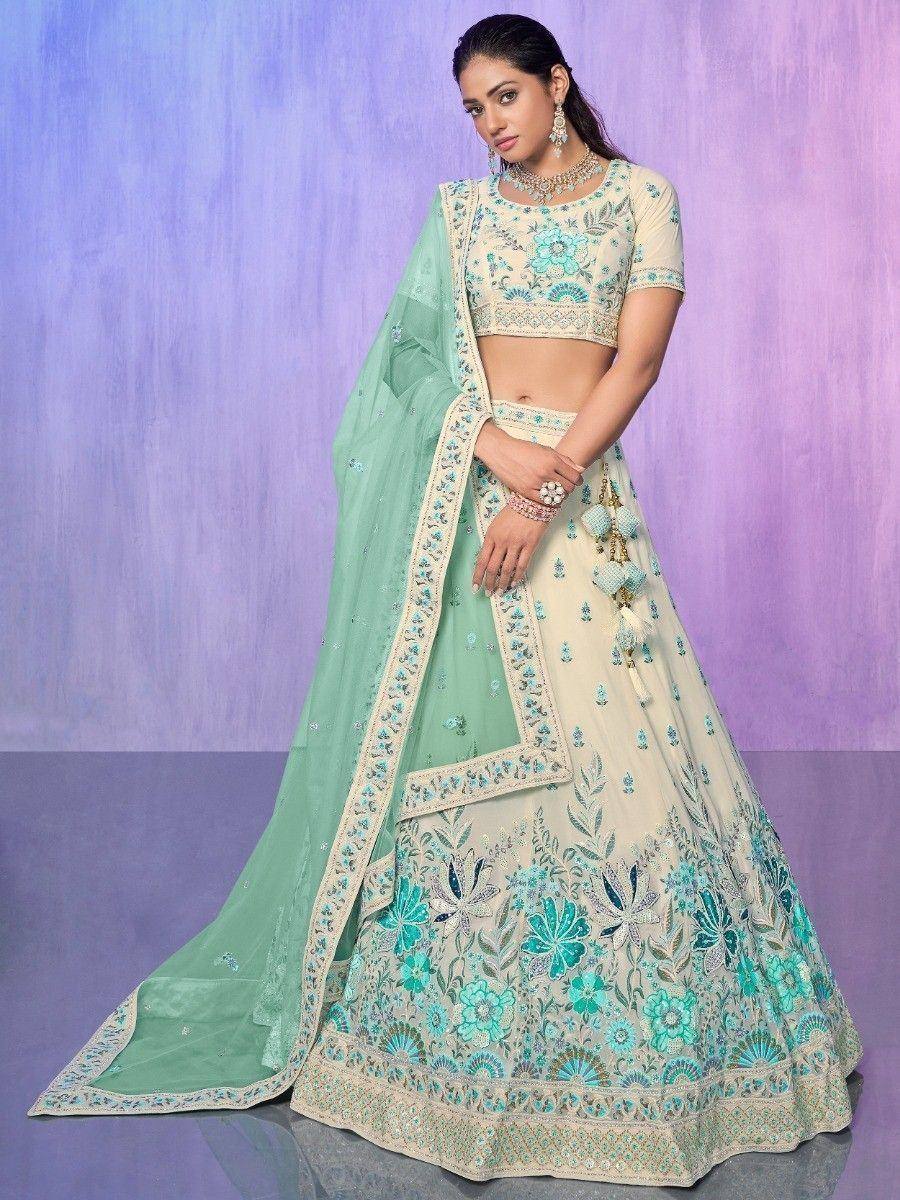 Cream and mint green embroidered lehenga choli with floral motifs and matching dupatta, perfect for Indian ethnic wear.