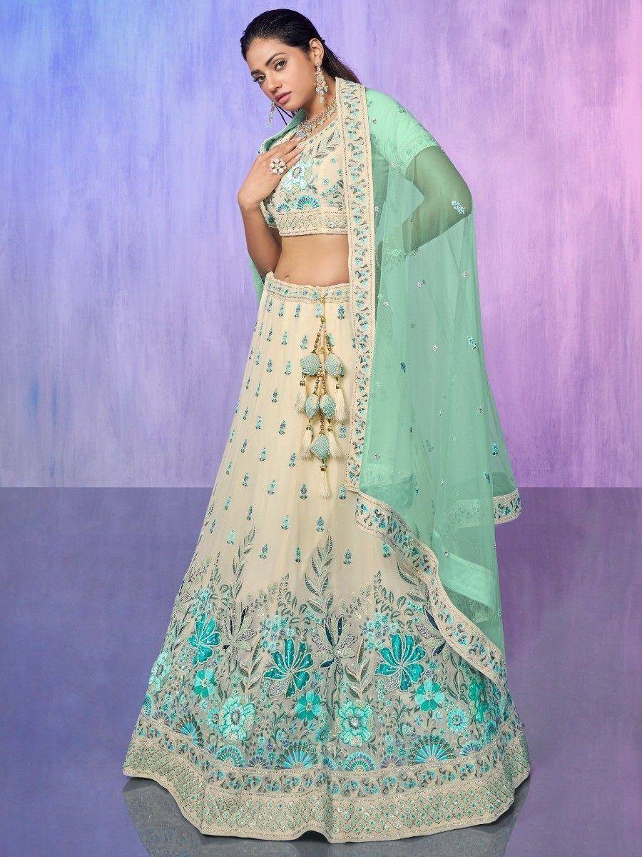 Elegant cream and mint green embroidered lehenga choli with floral motifs and sheer dupatta for Indian ethnic wear