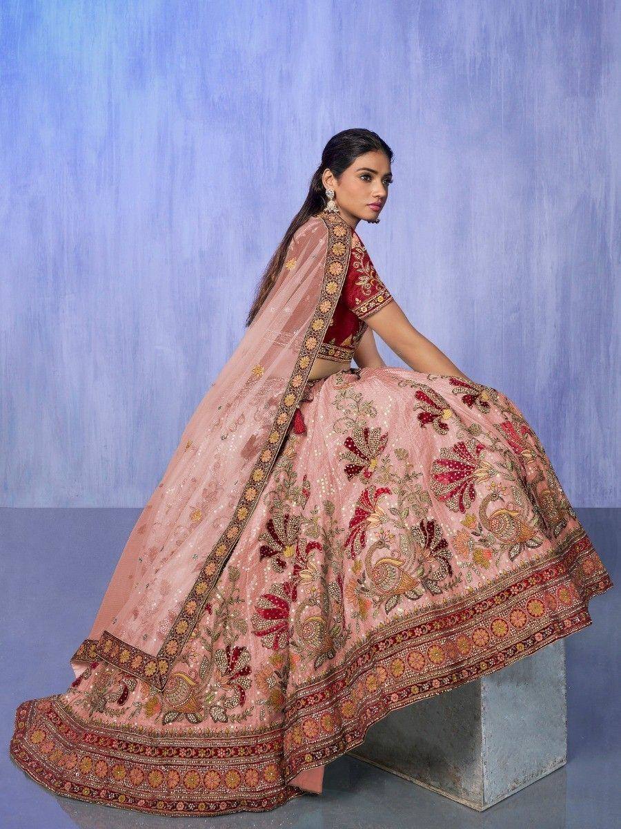 Pink embroidered lehenga choli with floral and peacock motifs, perfect for Indian weddings and festive occasions.