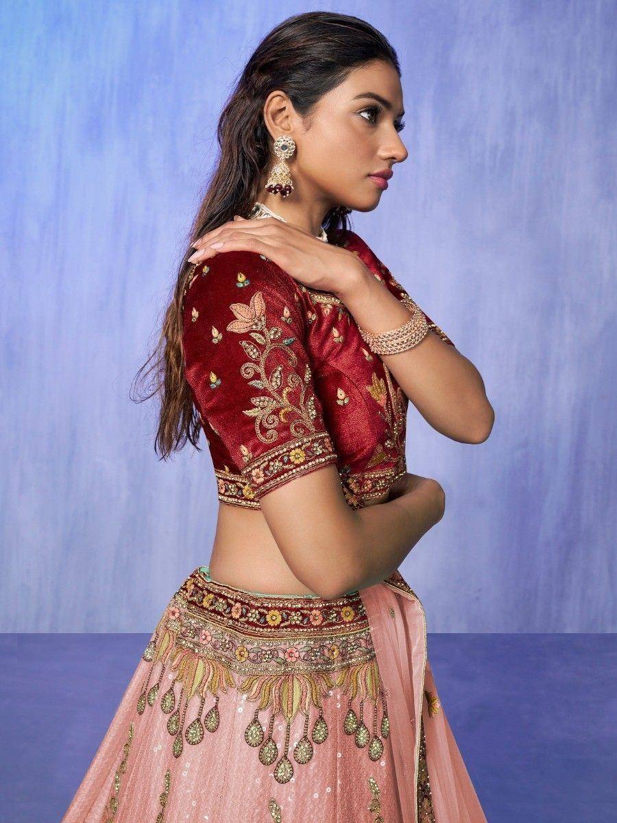Maroon embroidered lehenga choli with pink skirt, perfect for Indian weddings and festive occasions.