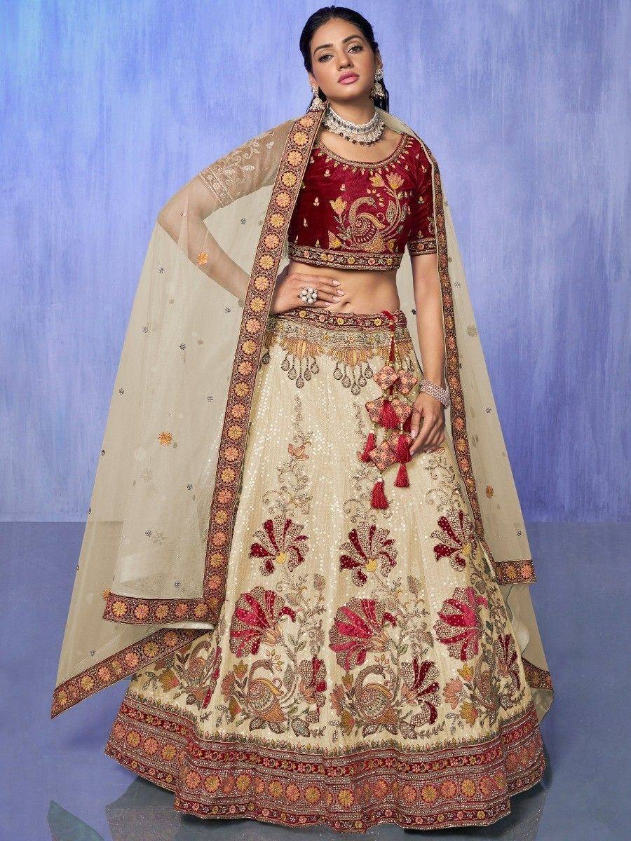Red and cream embroidered lehenga choli with floral motifs and dupatta, perfect for Indian weddings and festive occasions