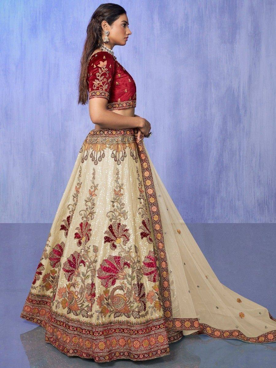 Elegant ivory and maroon embroidered lehenga choli with floral motifs, perfect for Indian weddings and festive occasions.