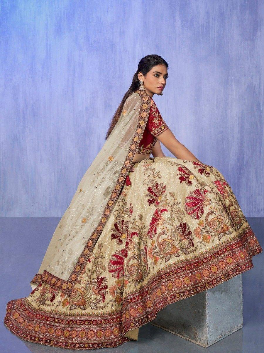 Cream and maroon embroidered lehenga choli with floral motifs, perfect for Indian weddings and festive occasions.
