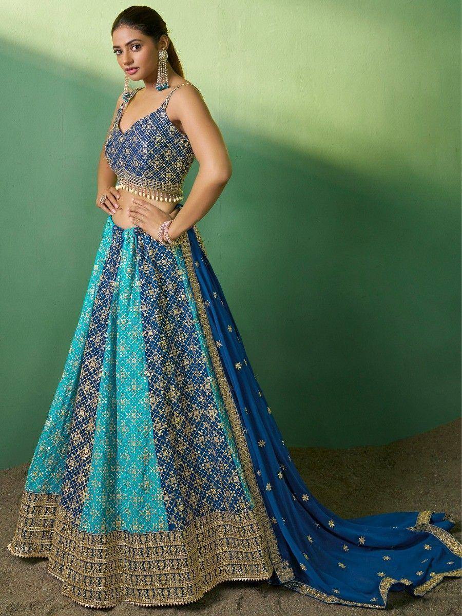 Blue and turquoise designer lehenga choli with gold embroidery, perfect for Indian weddings and festive occasions