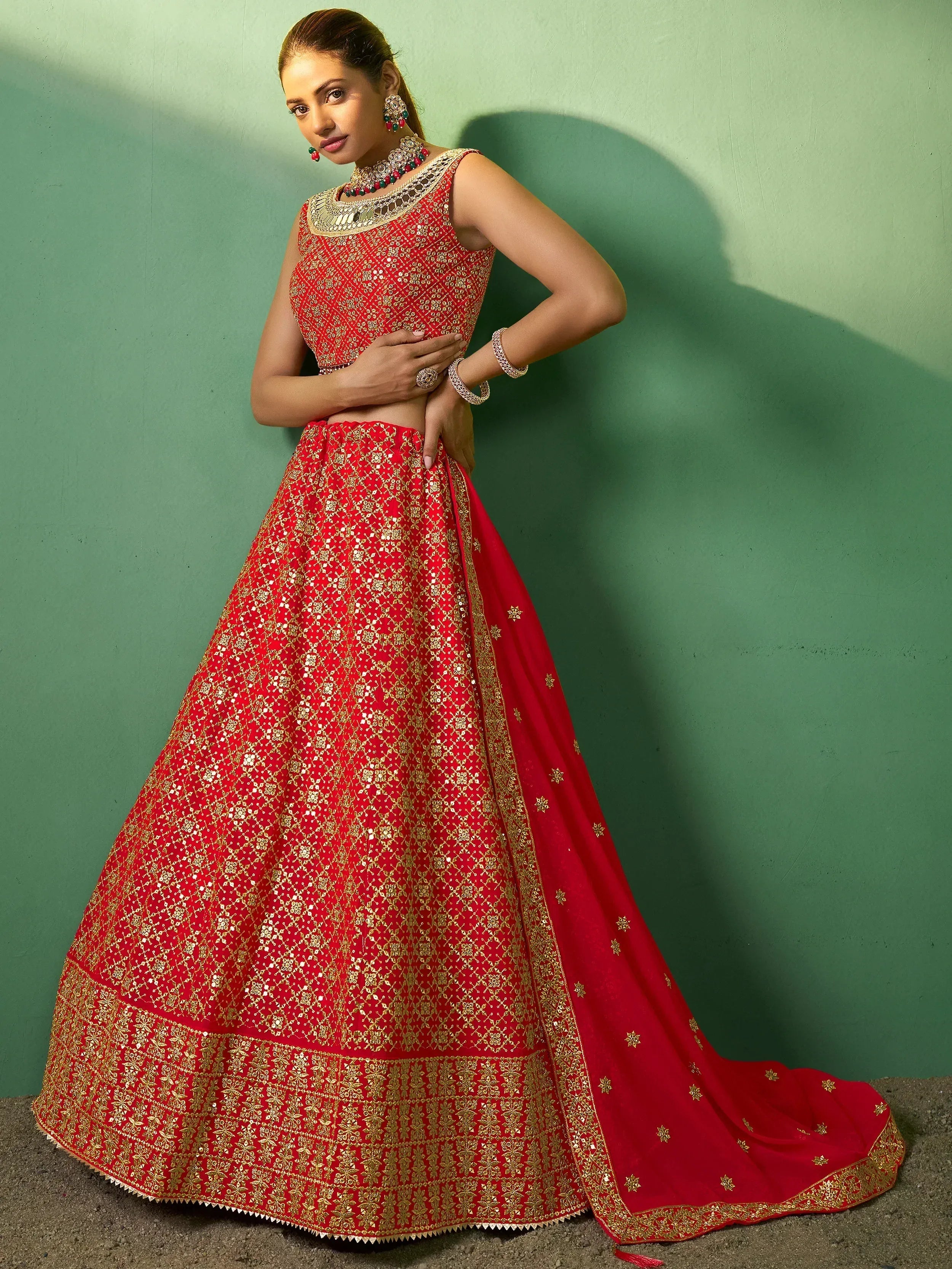 Red and gold embroidered lehenga choli with mirror work, perfect for Indian weddings and festive occasions