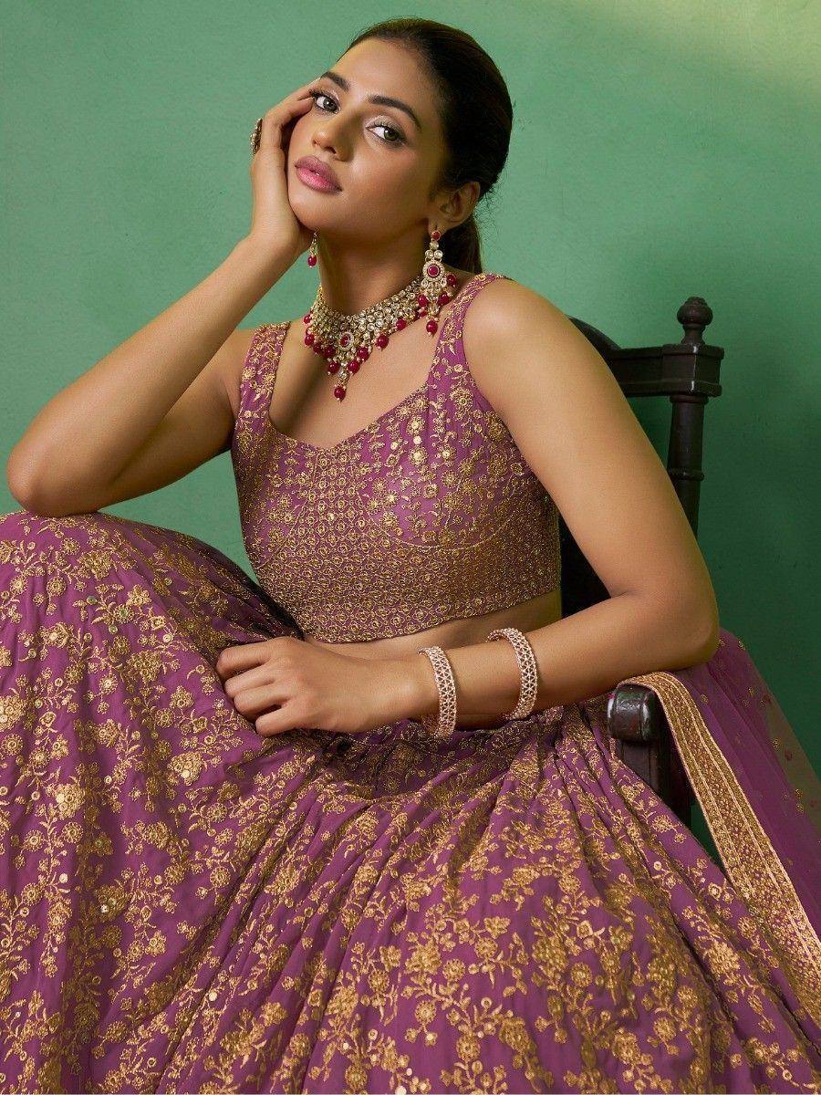 Purple and gold embroidered lehenga choli with matching jewelry, perfect for Indian ethnic occasions