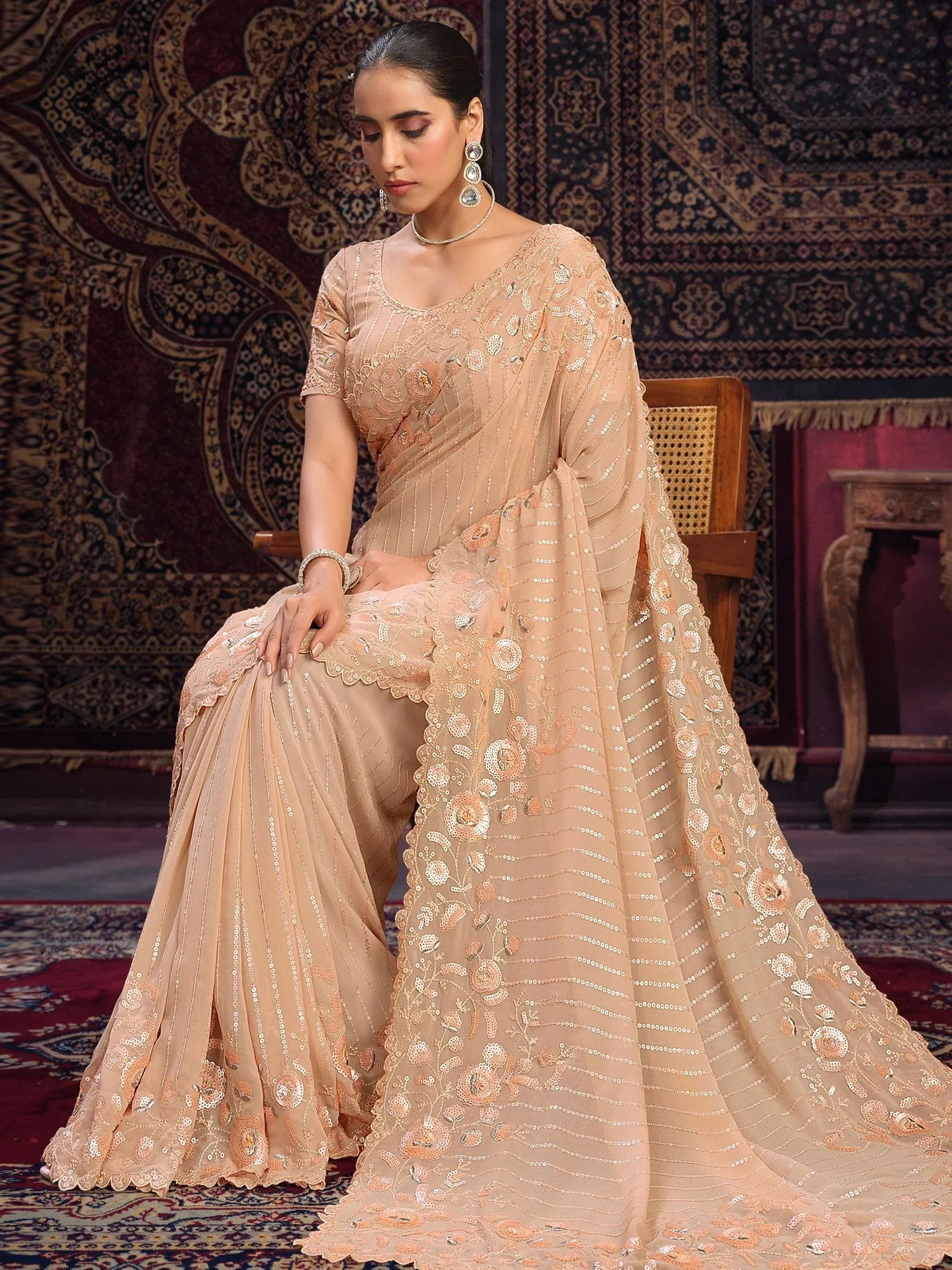 Elegant peach designer saree with floral embroidery and sequins, perfect for Indian ethnic wear occasions.