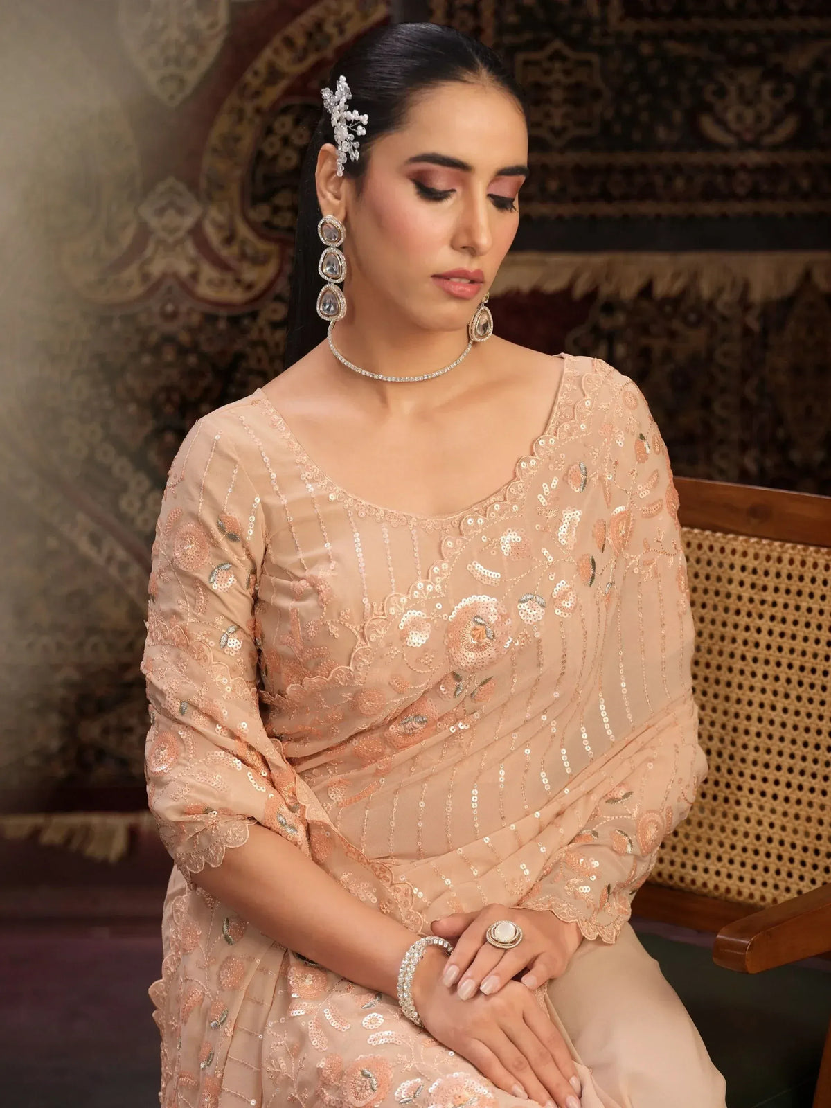 Elegant peach ethnic gown with sequin embroidery, perfect for Indian weddings or festive occasions.