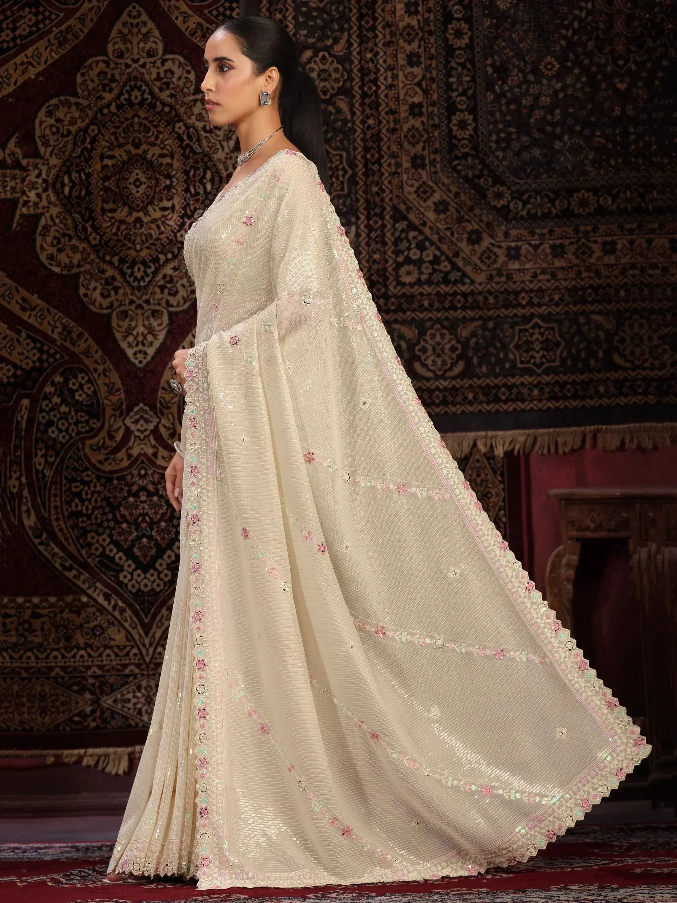 Elegant cream ethnic gown with floral embroidery and sequins, perfect for Indian celebrations.