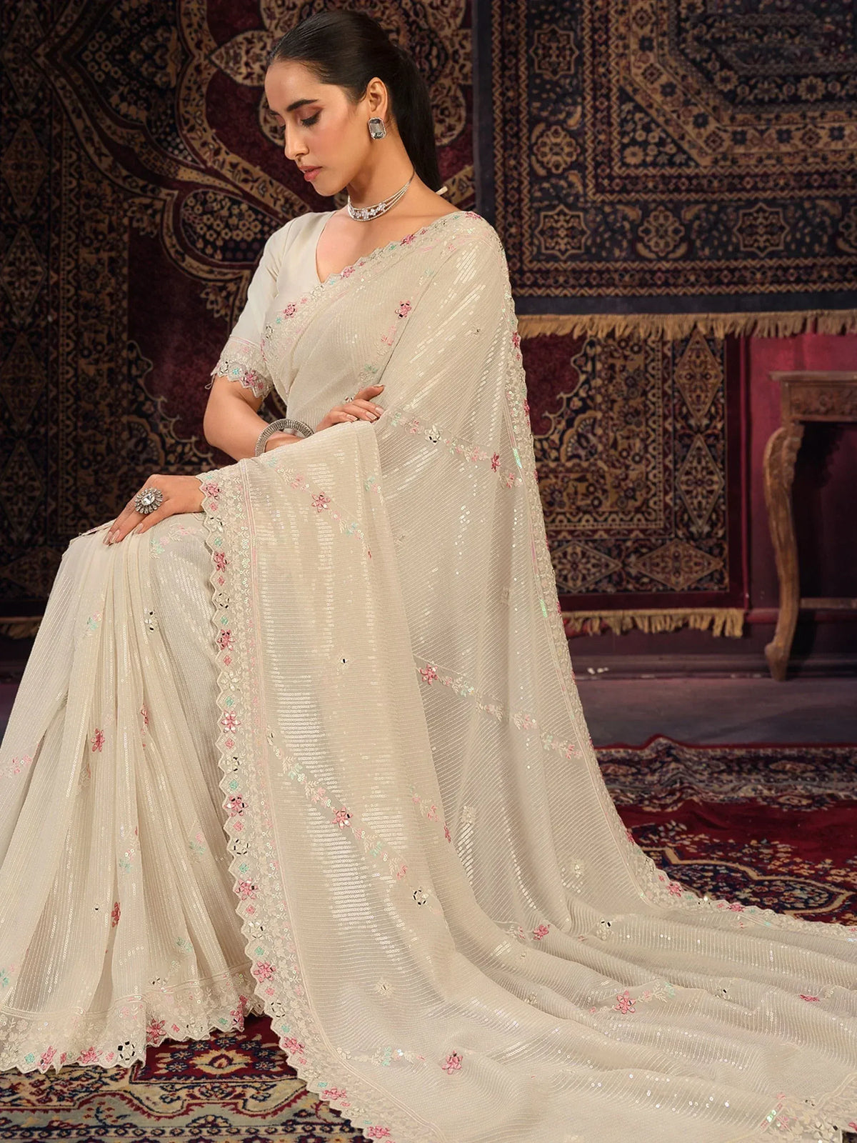 Elegant off-white saree with floral embroidery and sequins, styled with matching blouse for Indian ethnic wear
