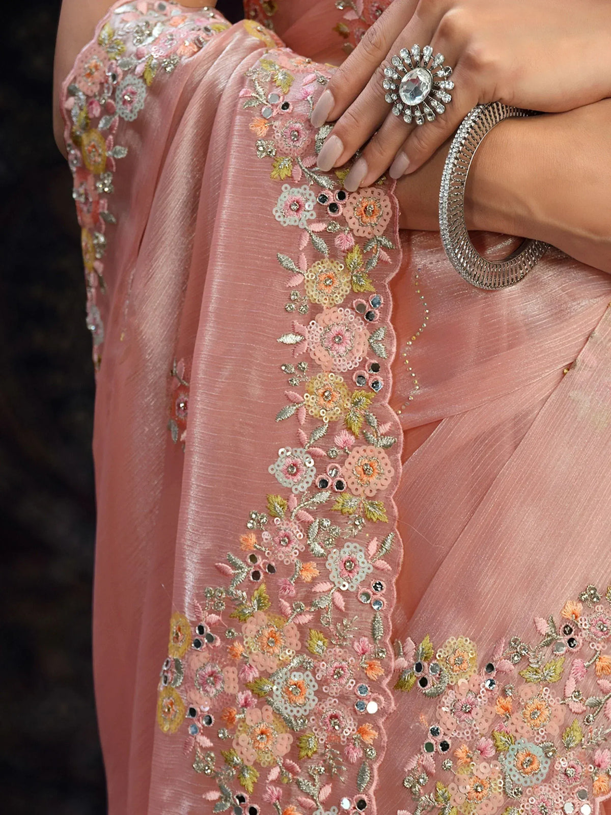 Pink floral embroidered saree with sequins and mirror work, paired with statement ring and bangle