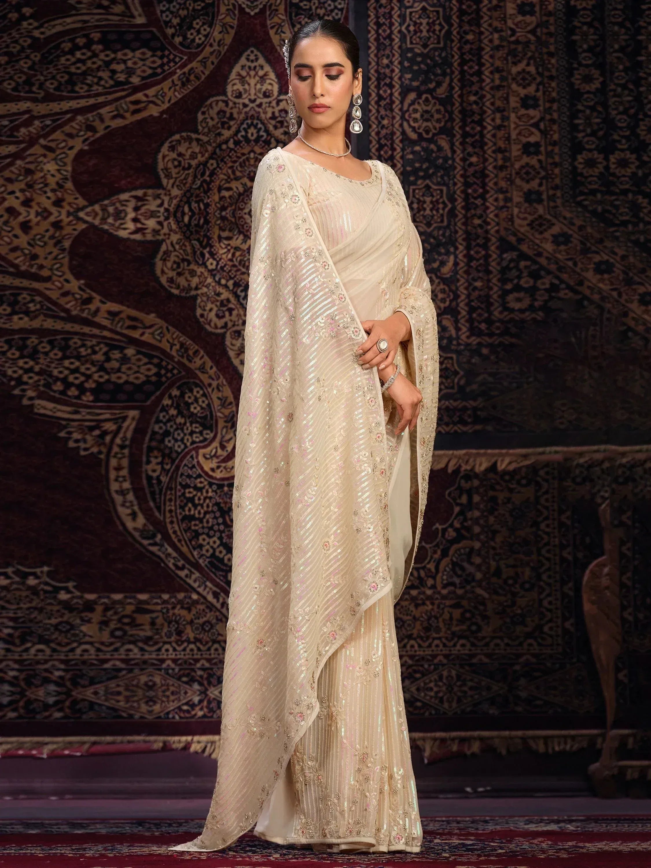 Elegant cream saree with sequin embroidery, perfect for Indian ethnic wear and festive occasions.