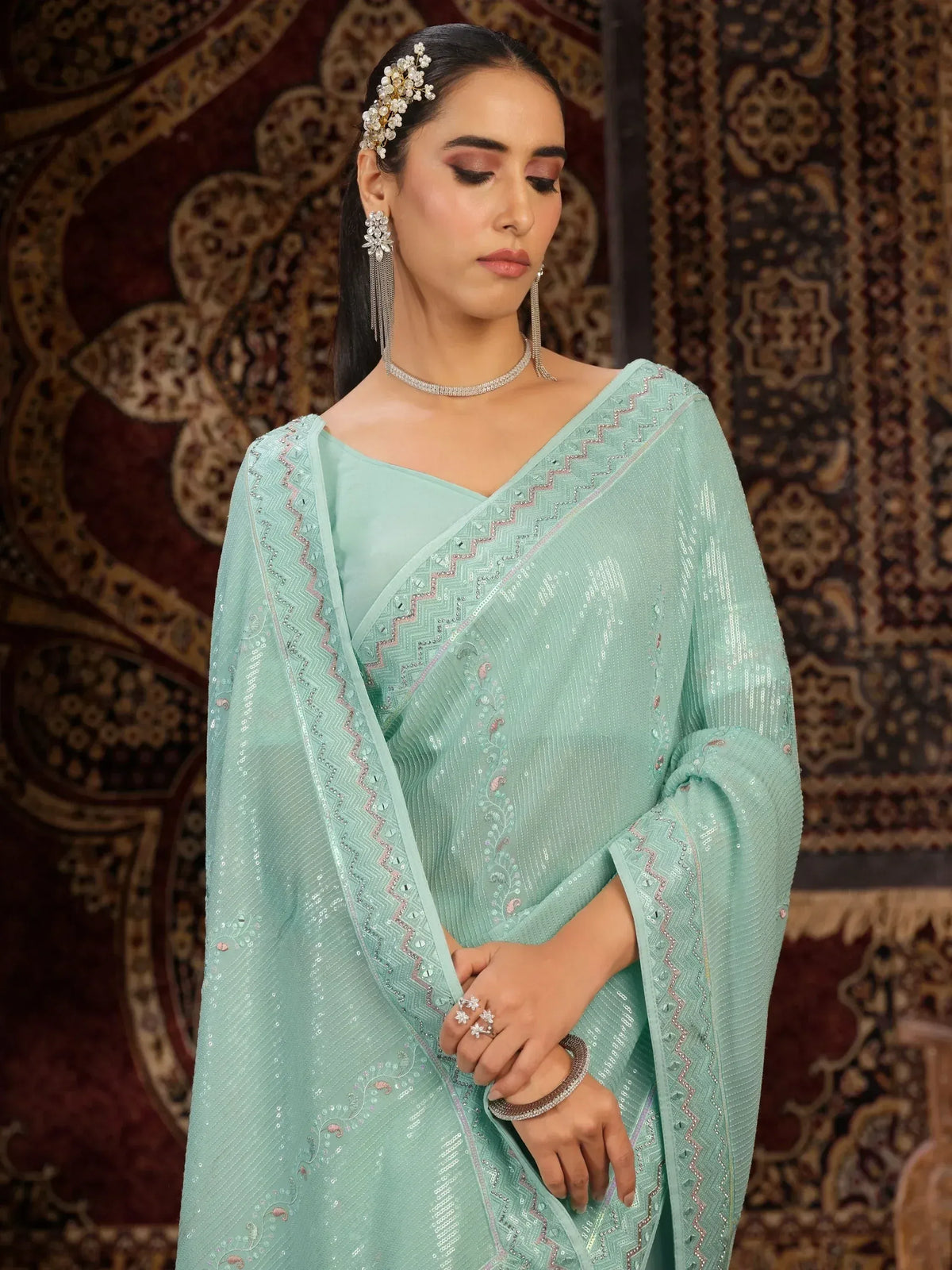 Mint green sequined saree with zigzag border, perfect for Indian ethnic wear events