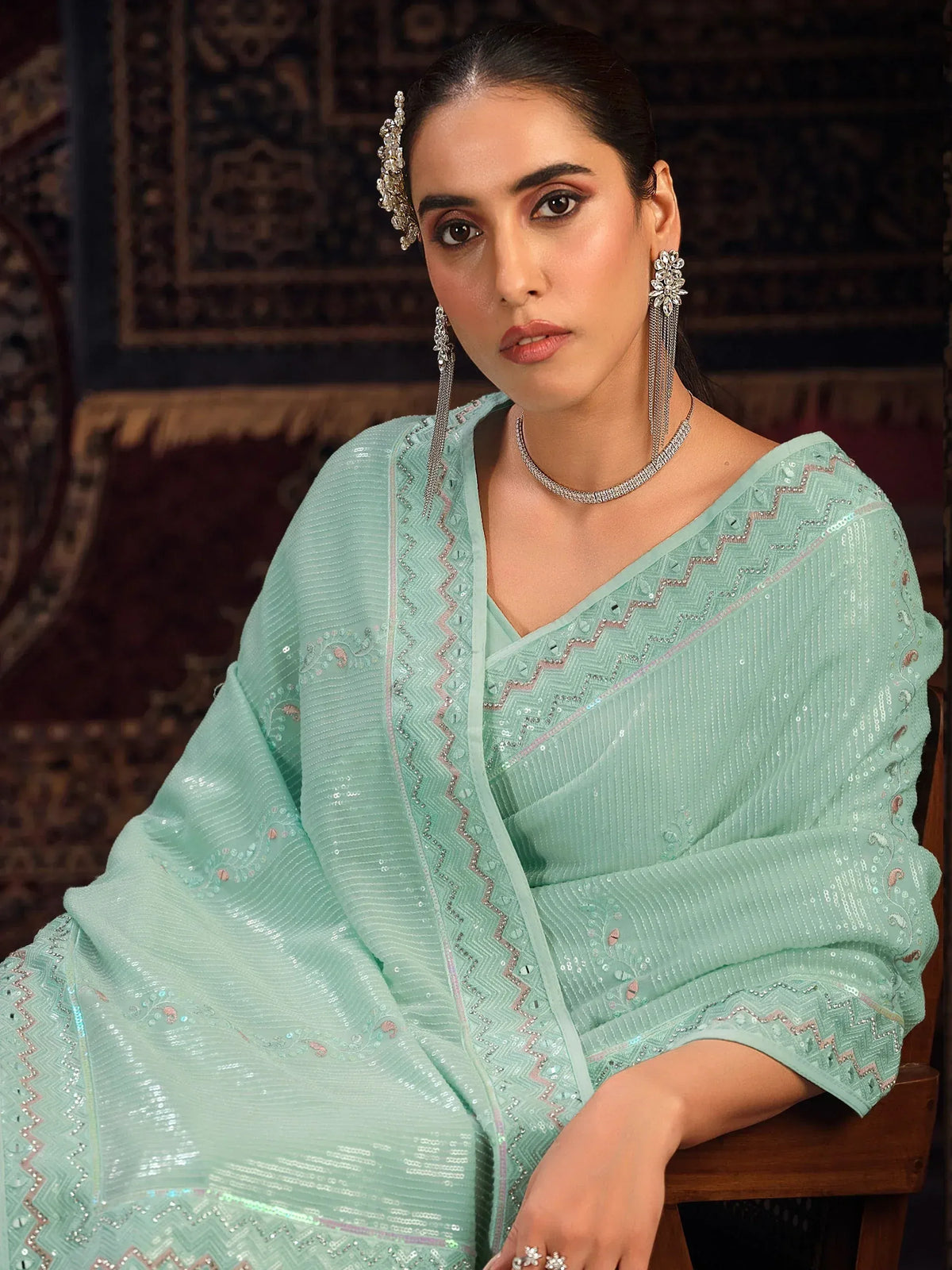 Mint green designer saree with sequin embroidery and matching jewelry for Indian ethnic wear