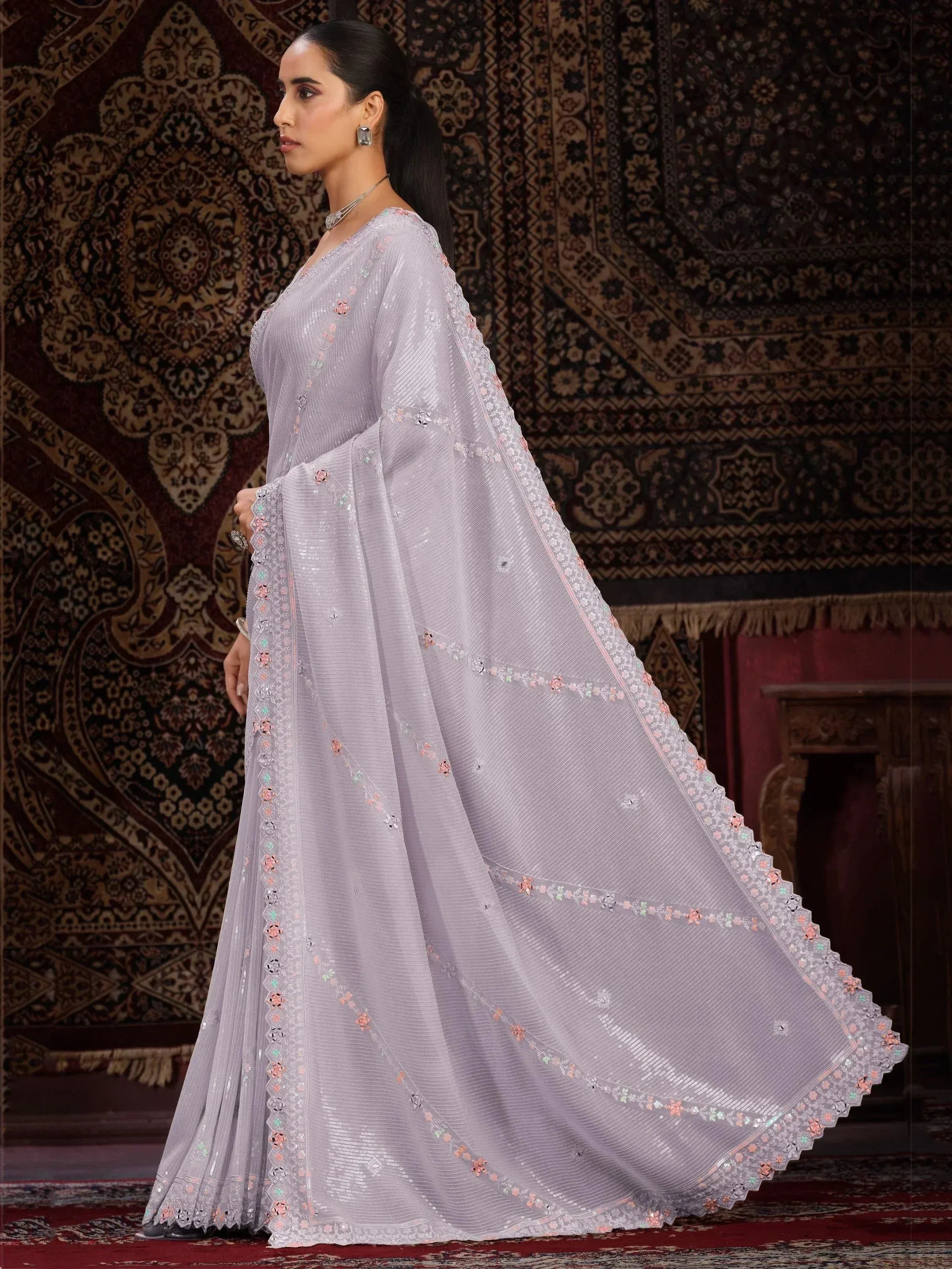 Elegant lavender ethnic gown with floral sequin embroidery, perfect for Indian weddings or festive occasions.