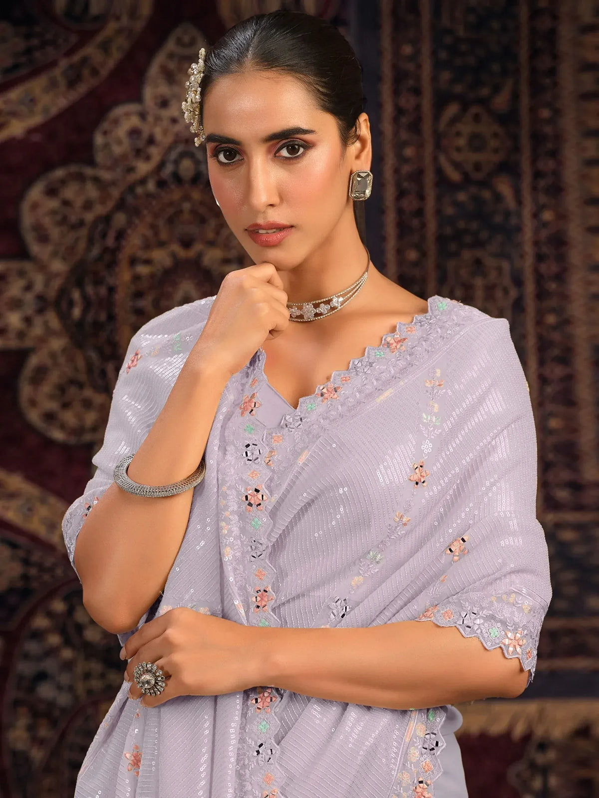 Lavender ethnic gown with floral embroidery and sequins, styled with traditional jewelry for festive occasions