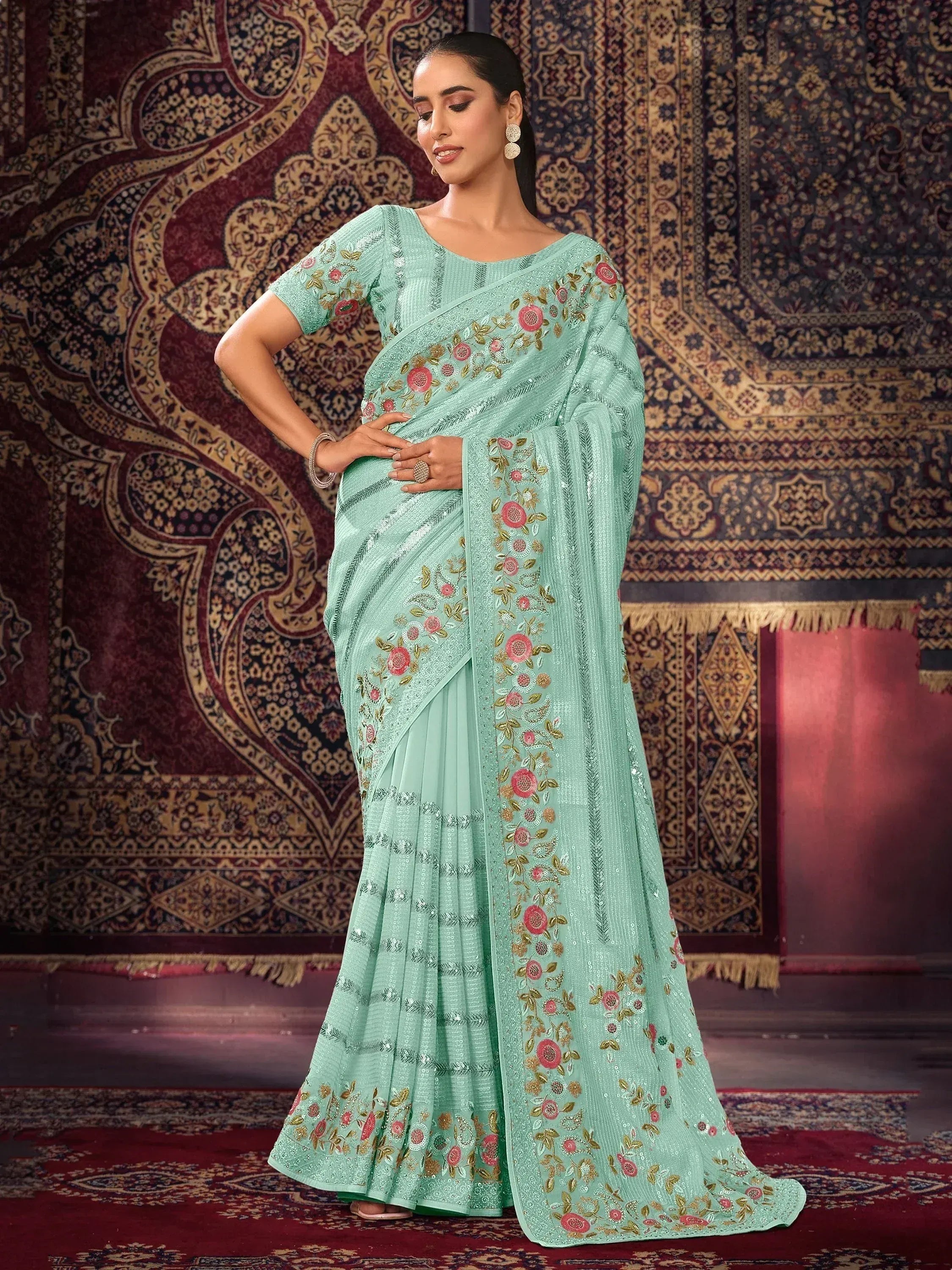 Mint green embroidered saree with floral motifs, perfect for Indian ethnic wear occasions