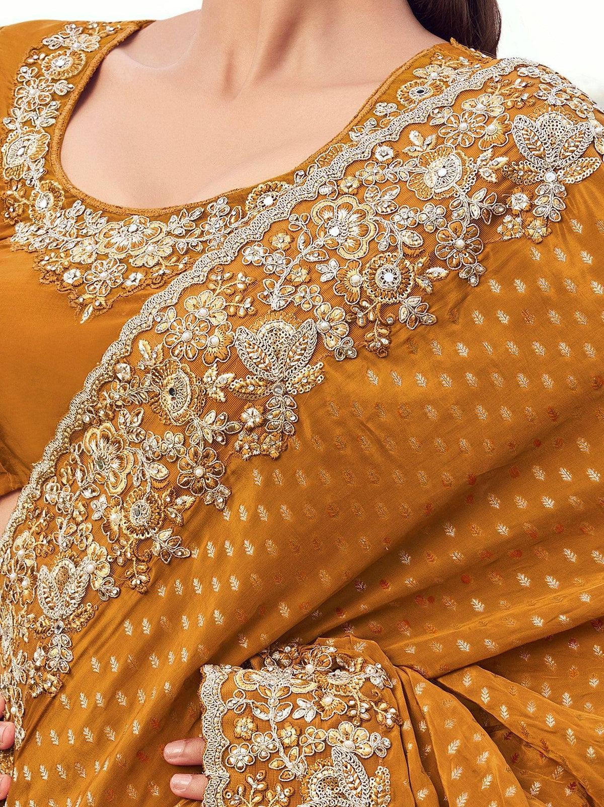 Mustard yellow saree with intricate white floral embroidery and embellished border, perfect for ethnic occasions.