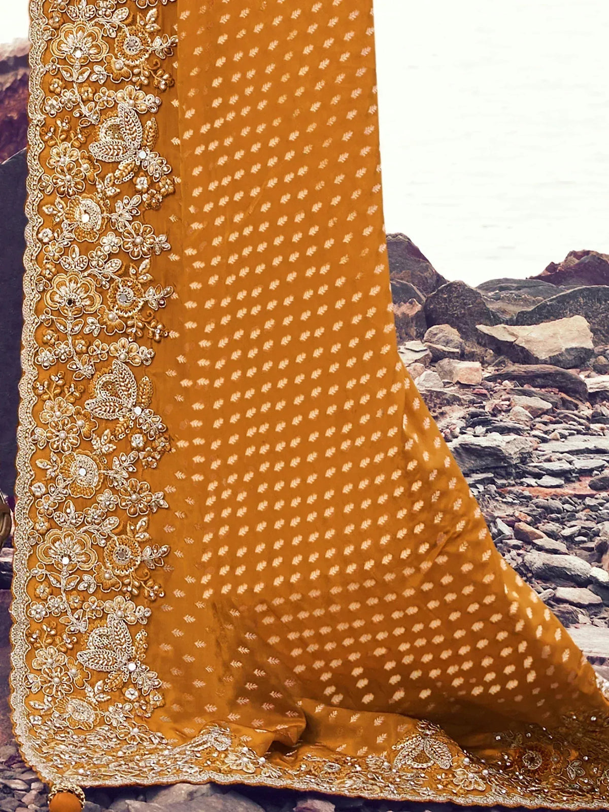 Mustard yellow ethnic lehenga with intricate gold embroidery and floral motifs, perfect for Indian weddings and festive occasions.
