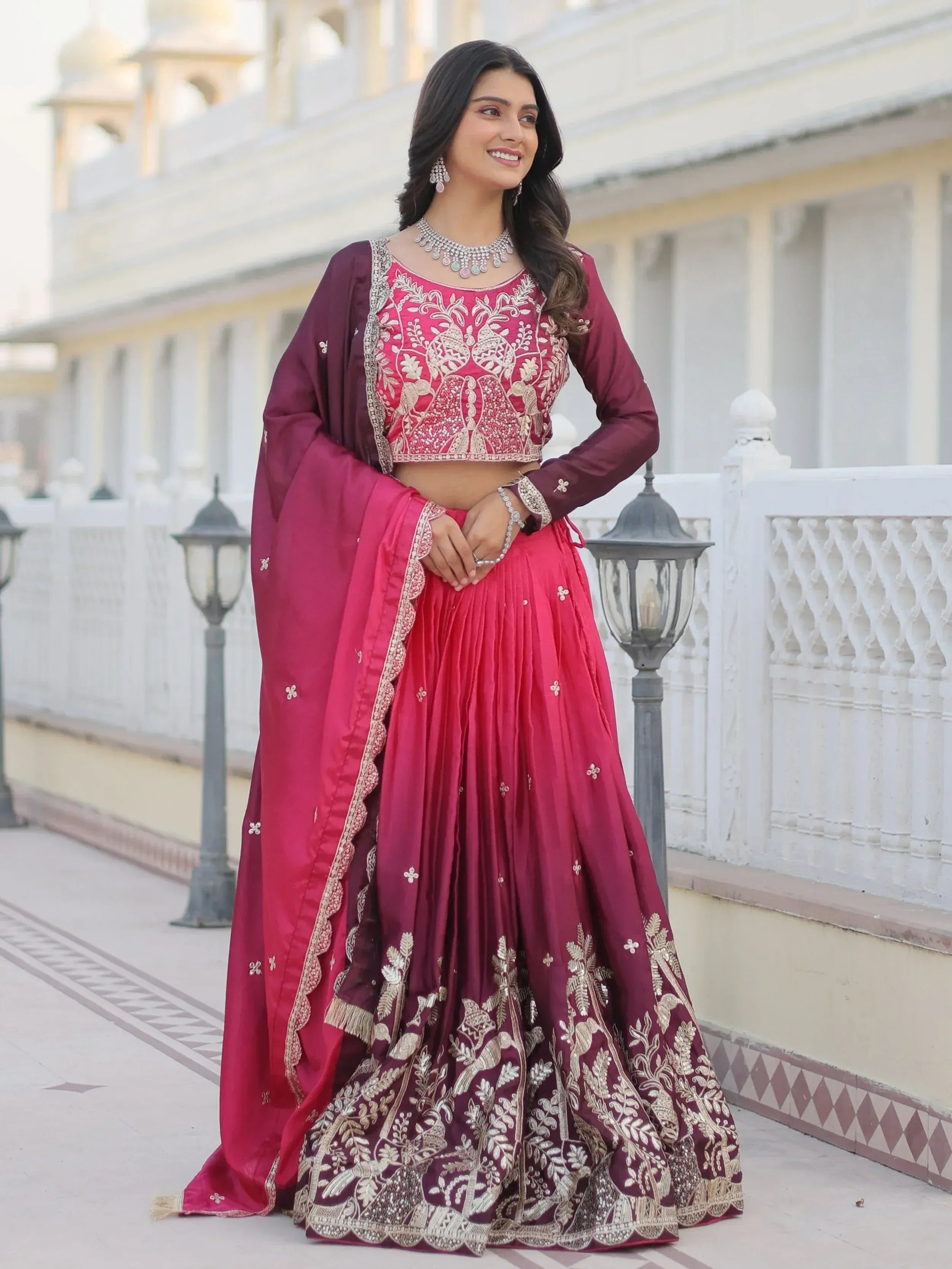 Elegant maroon lehenga choli with gold embroidery, perfect for Indian weddings and festive occasions.