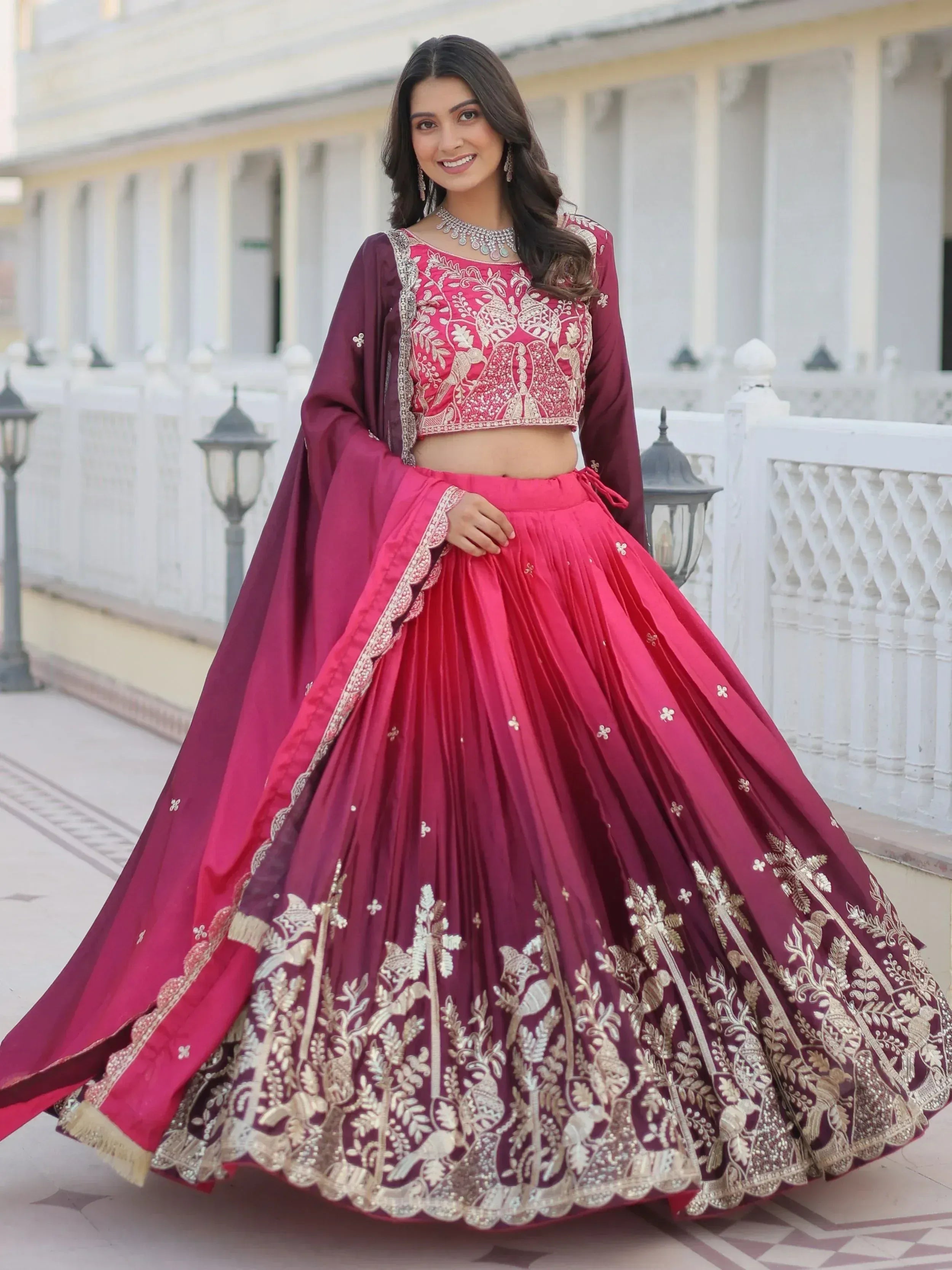 Elegant maroon and pink embroidered lehenga choli with gold detailing, perfect for Indian weddings and festive occasions.