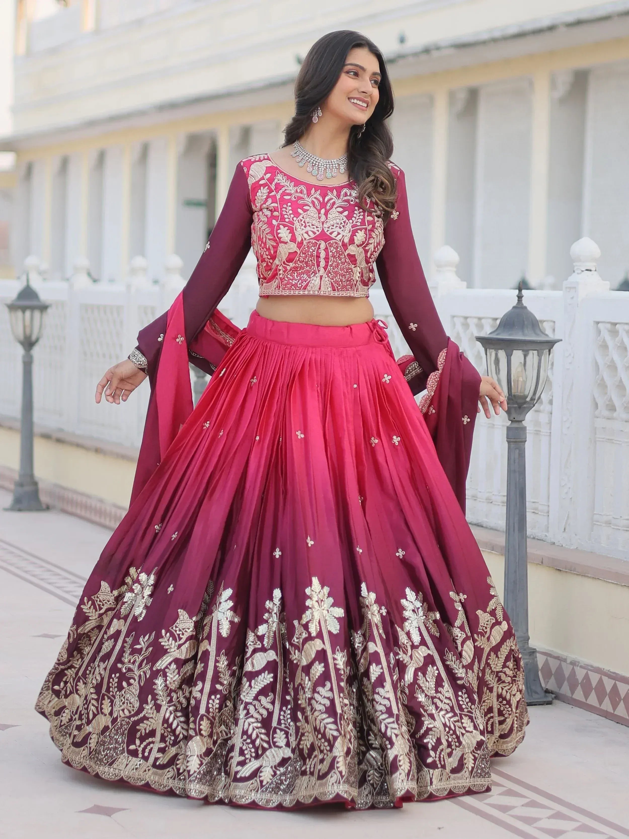 Elegant maroon lehenga choli with gold embroidery, perfect for Indian weddings and festive occasions.