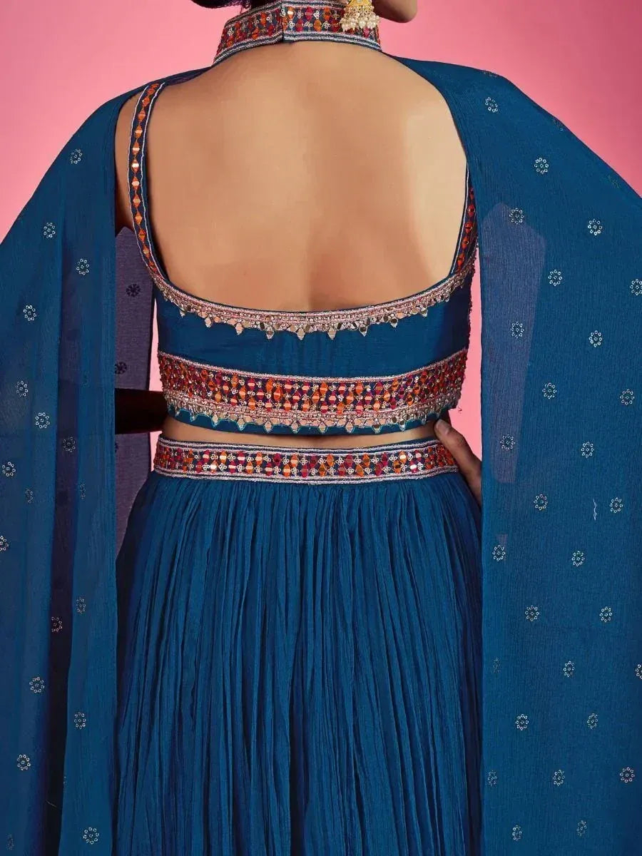 Blue ethnic lehenga choli with mirror work, open back blouse, and dupatta for Indian weddings