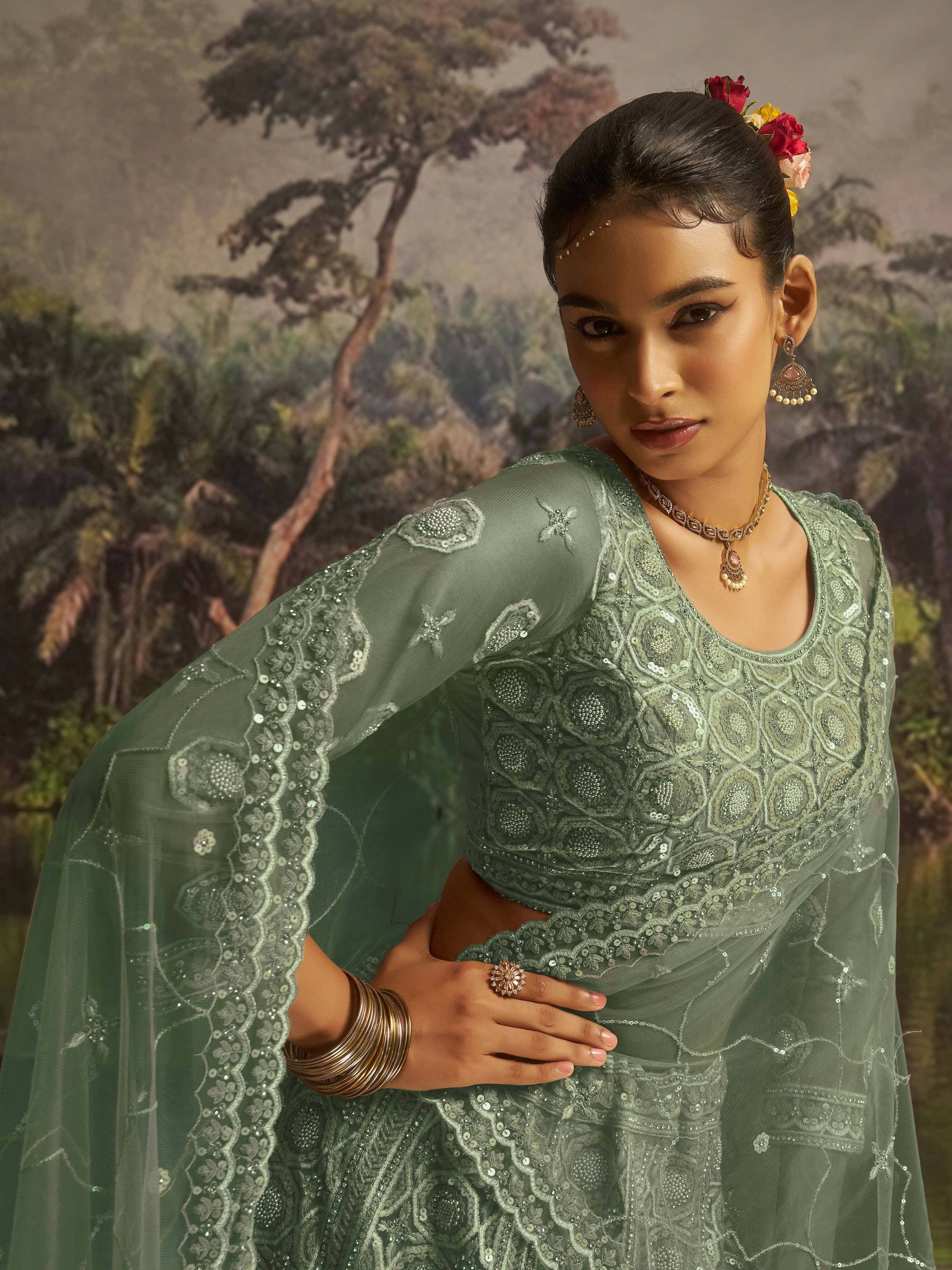 Elegant green embroidered lehenga choli with floral hair accessories and traditional jewelry