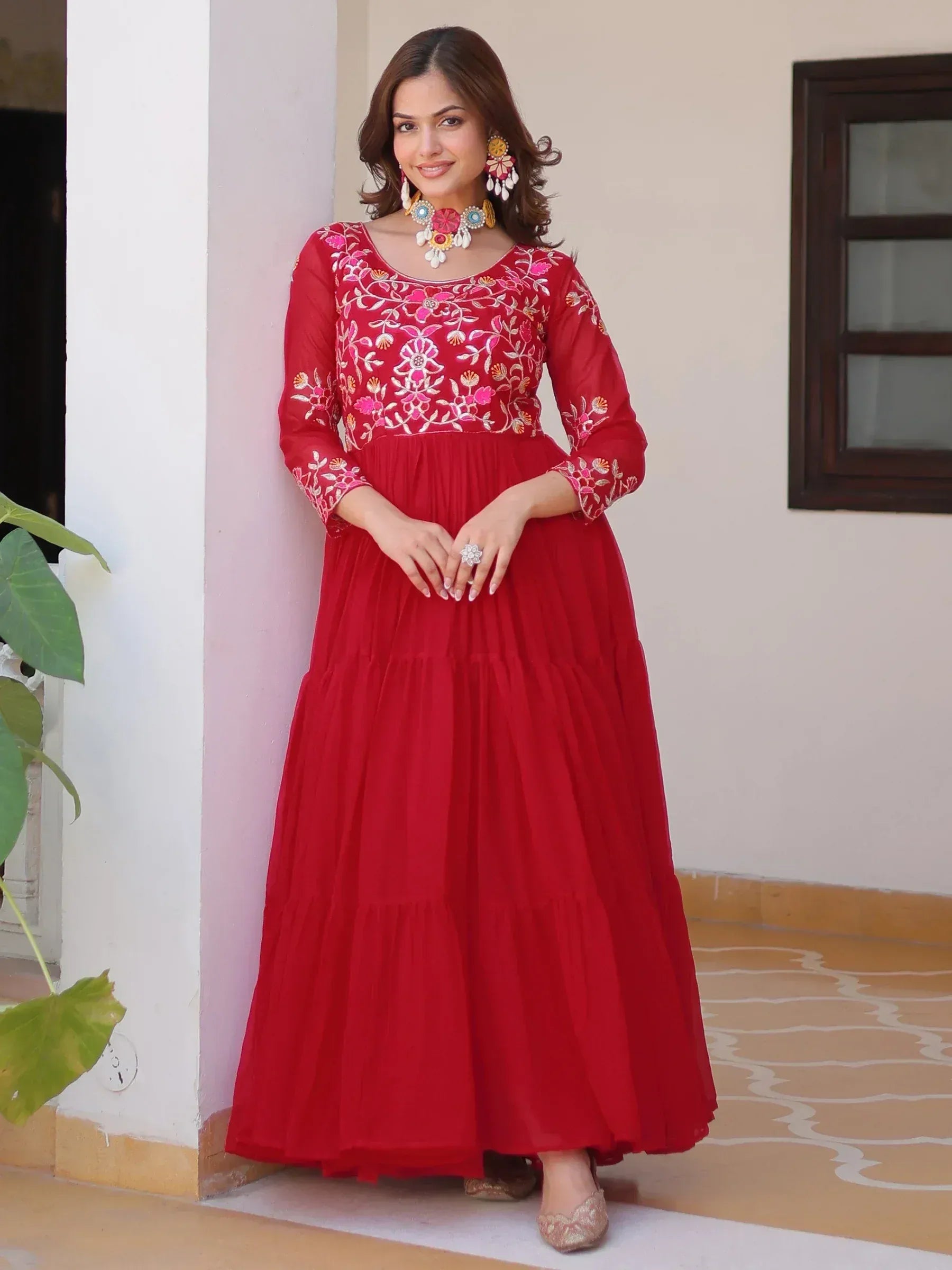 Red embroidered ethnic gown with floral detailing, perfect for Indian festive occasions