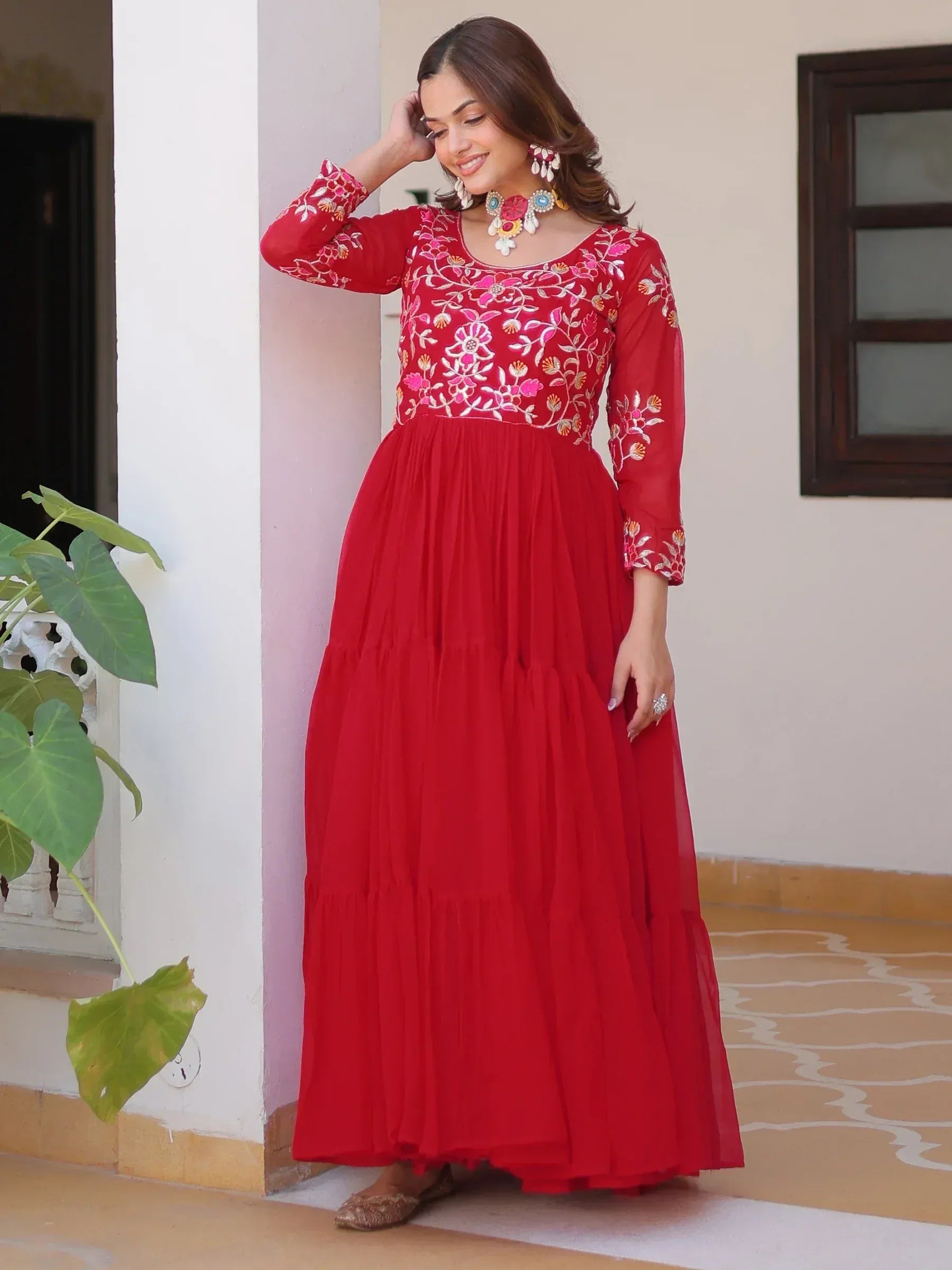 Red embroidered ethnic gown with floral detailing, perfect for Indian festive occasions and weddings.
