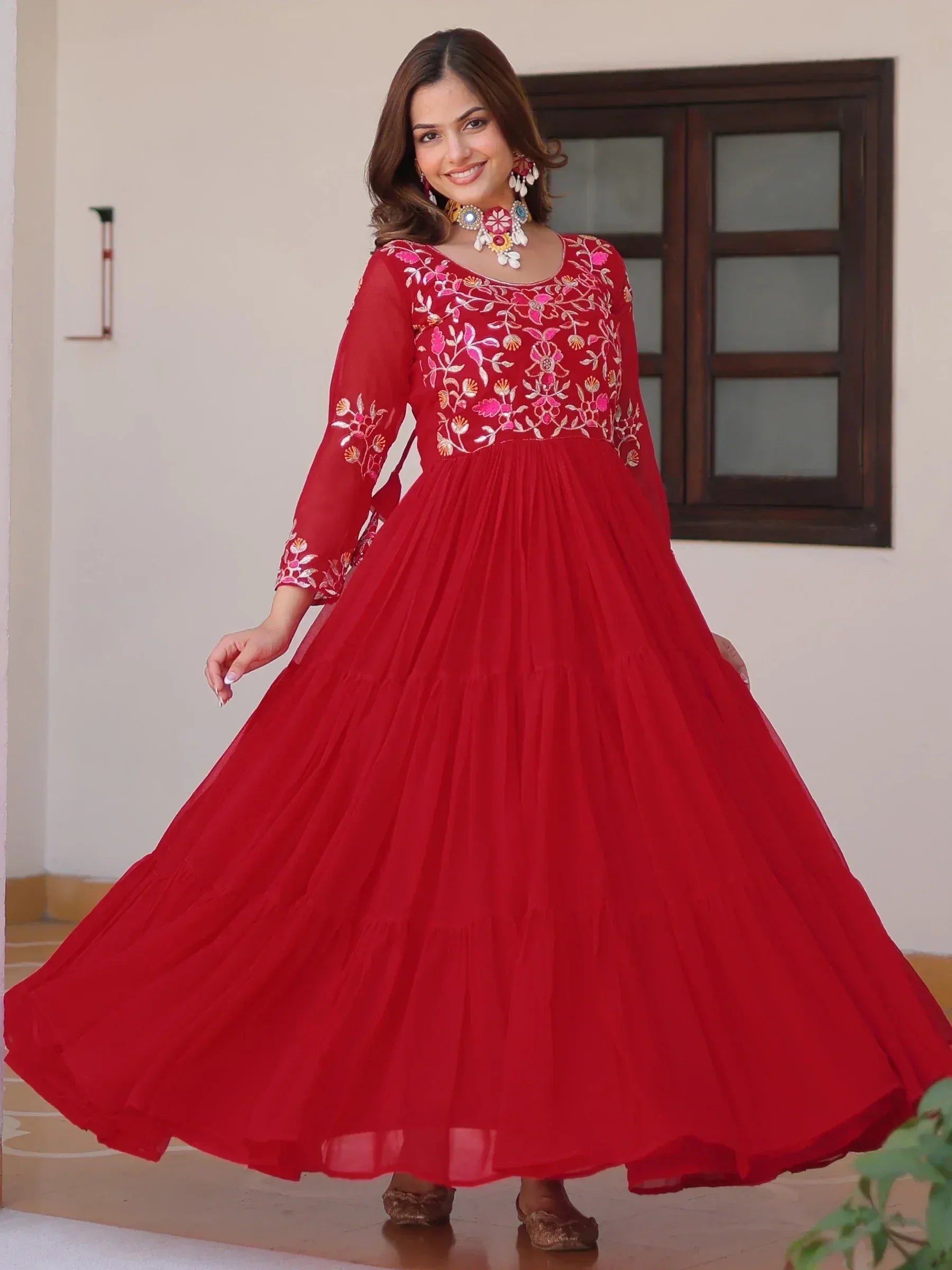 Red embroidered ethnic gown with floral detailing, perfect for Indian festive occasions and weddings.