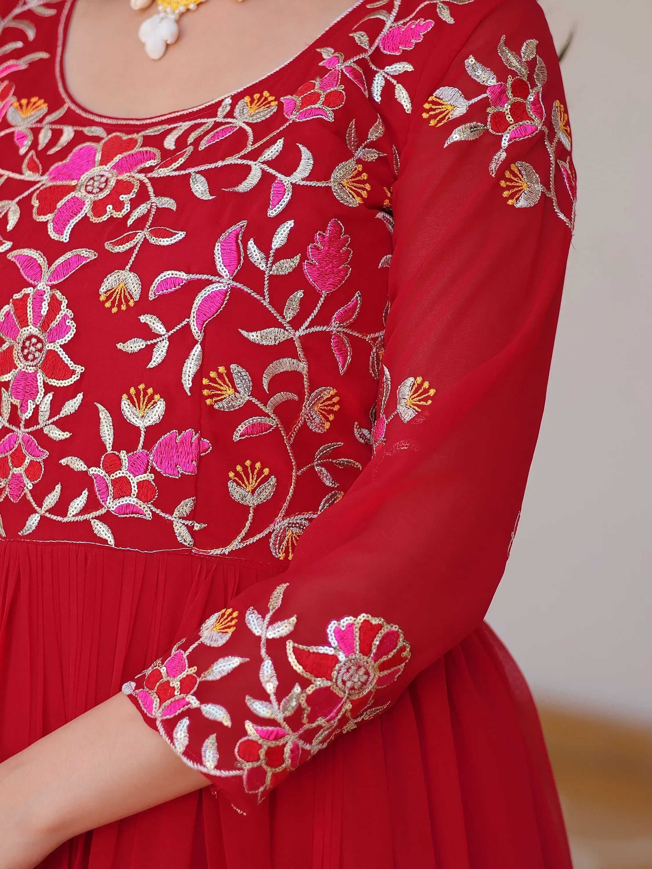 Red ethnic gown with pink and gold floral embroidery, perfect for Indian occasions