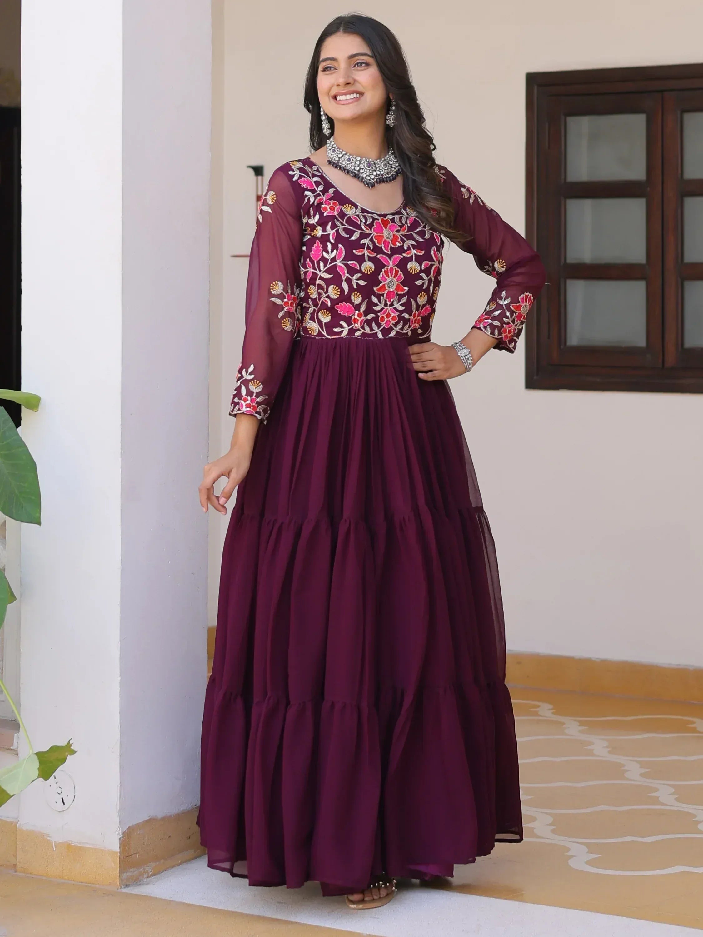 Maroon embroidered ethnic gown with floral detailing, perfect for Indian occasions and festive wear.