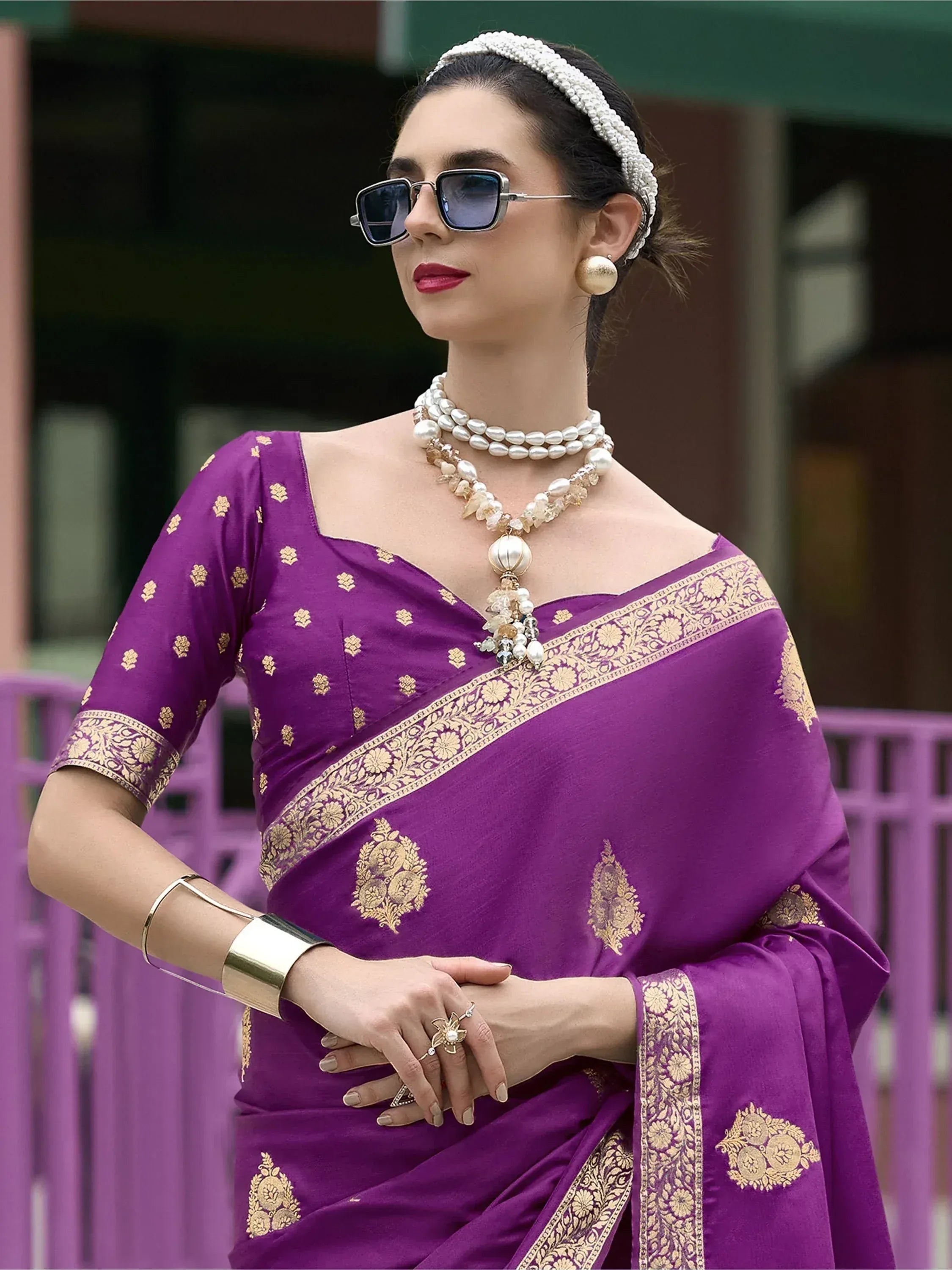 Purple saree with gold embroidery, styled with pearl jewelry and sunglasses for ethnic fashion