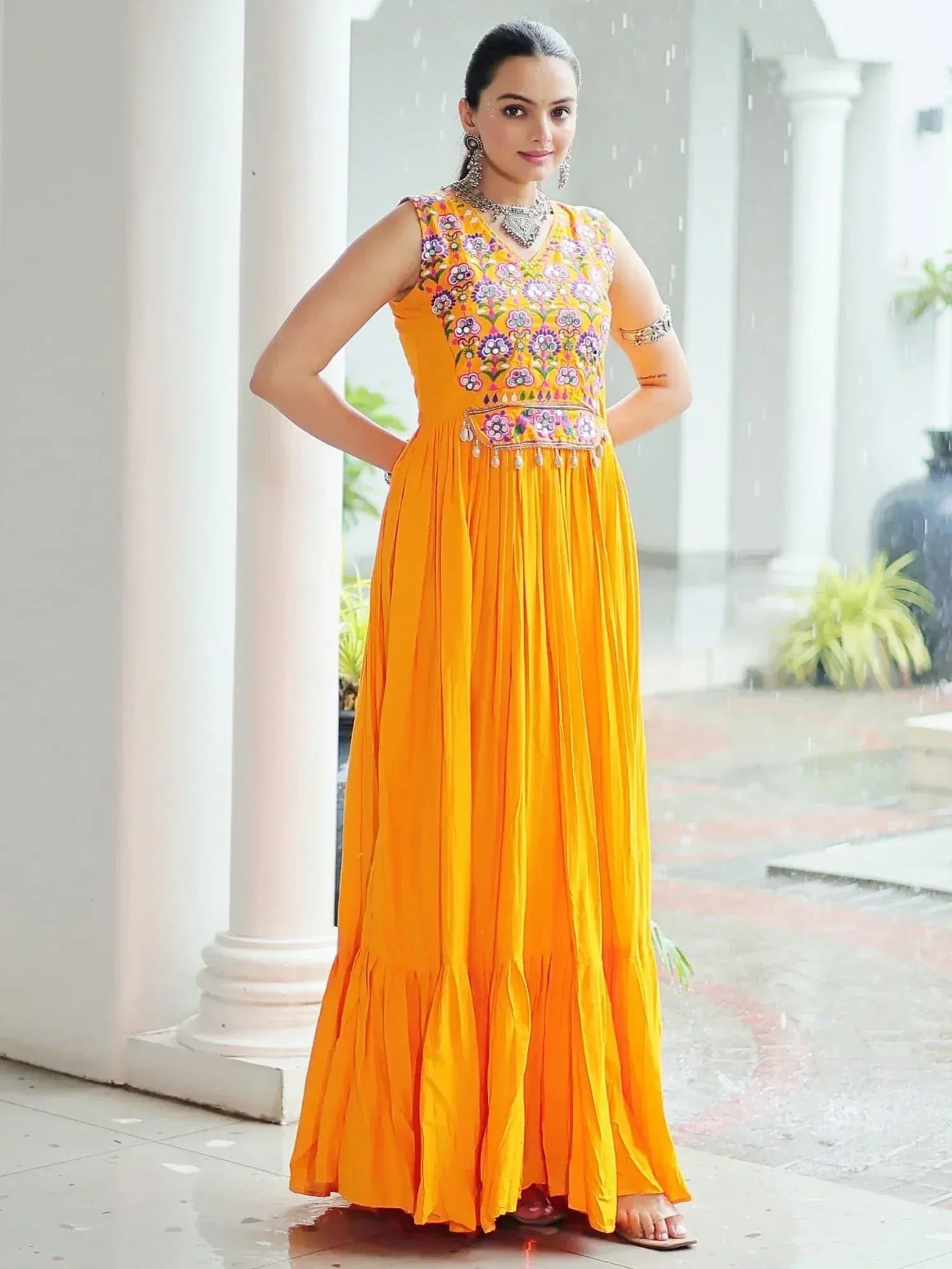 Vibrant yellow ethnic gown with floral embroidery, perfect for Indian festive occasions and weddings.