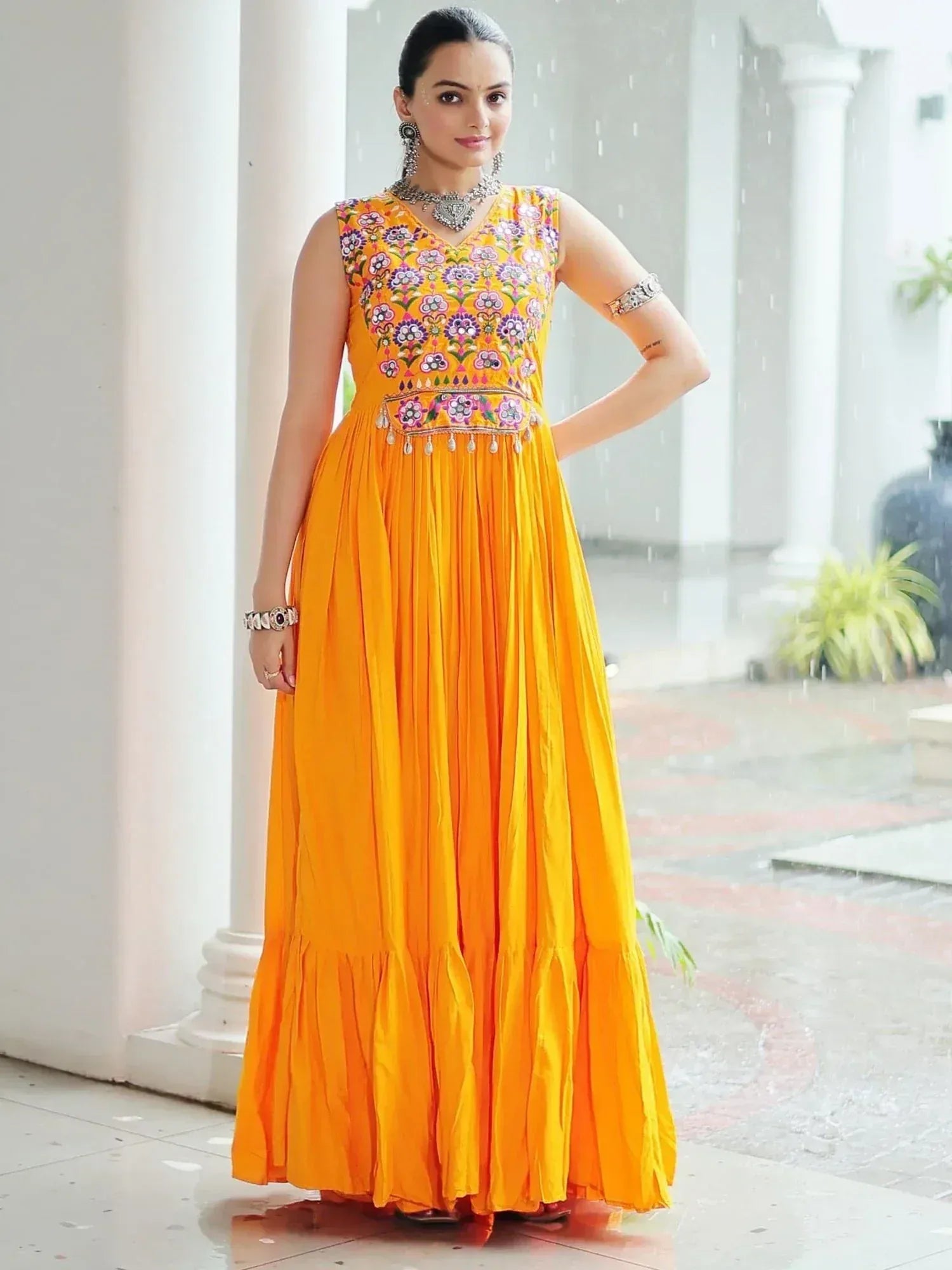 Vibrant yellow ethnic gown with floral embroidery, perfect for Indian celebrations and festive occasions.