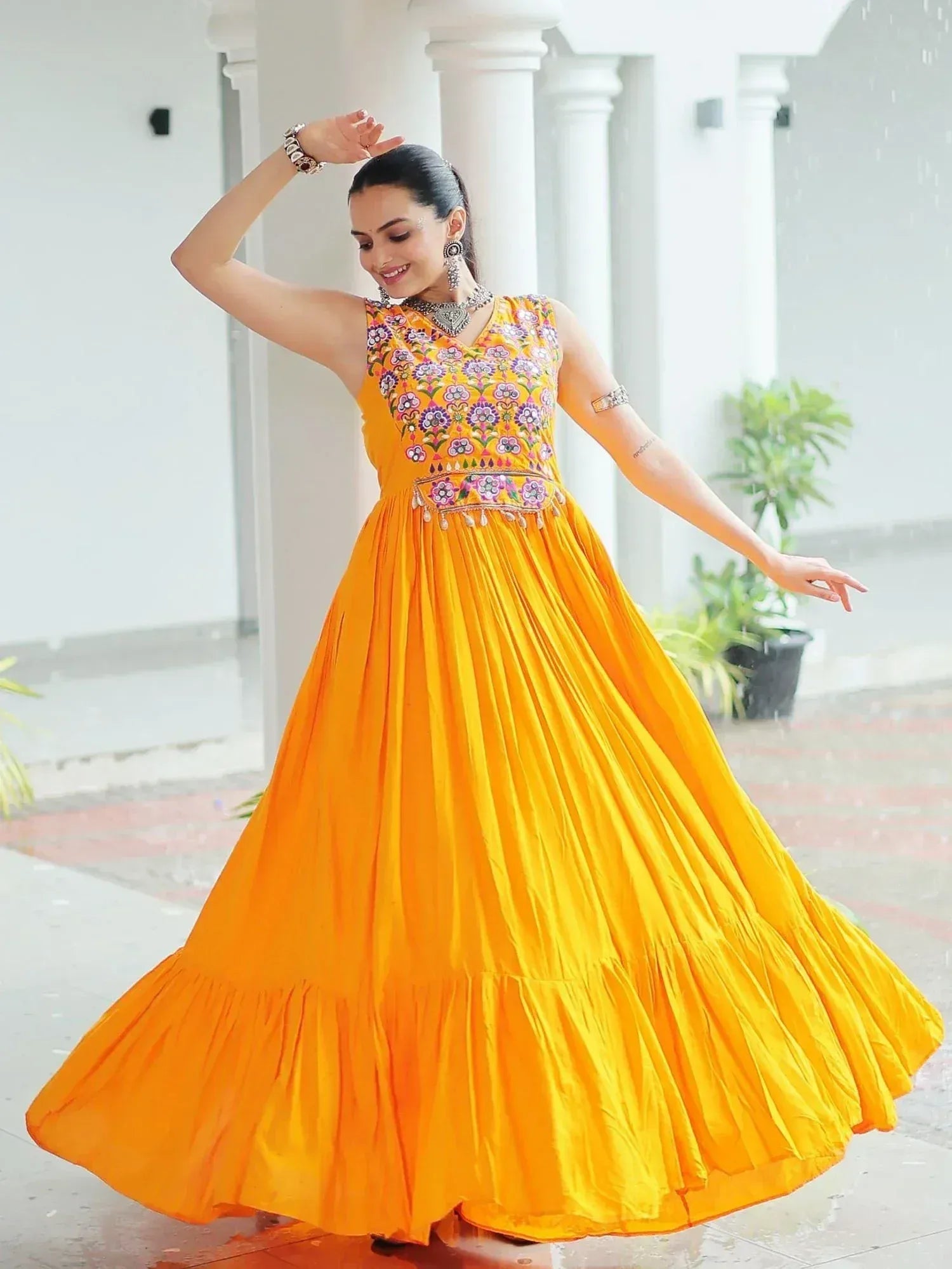 Vibrant yellow ethnic gown with floral embroidery, perfect for festive occasions and Indian celebrations.