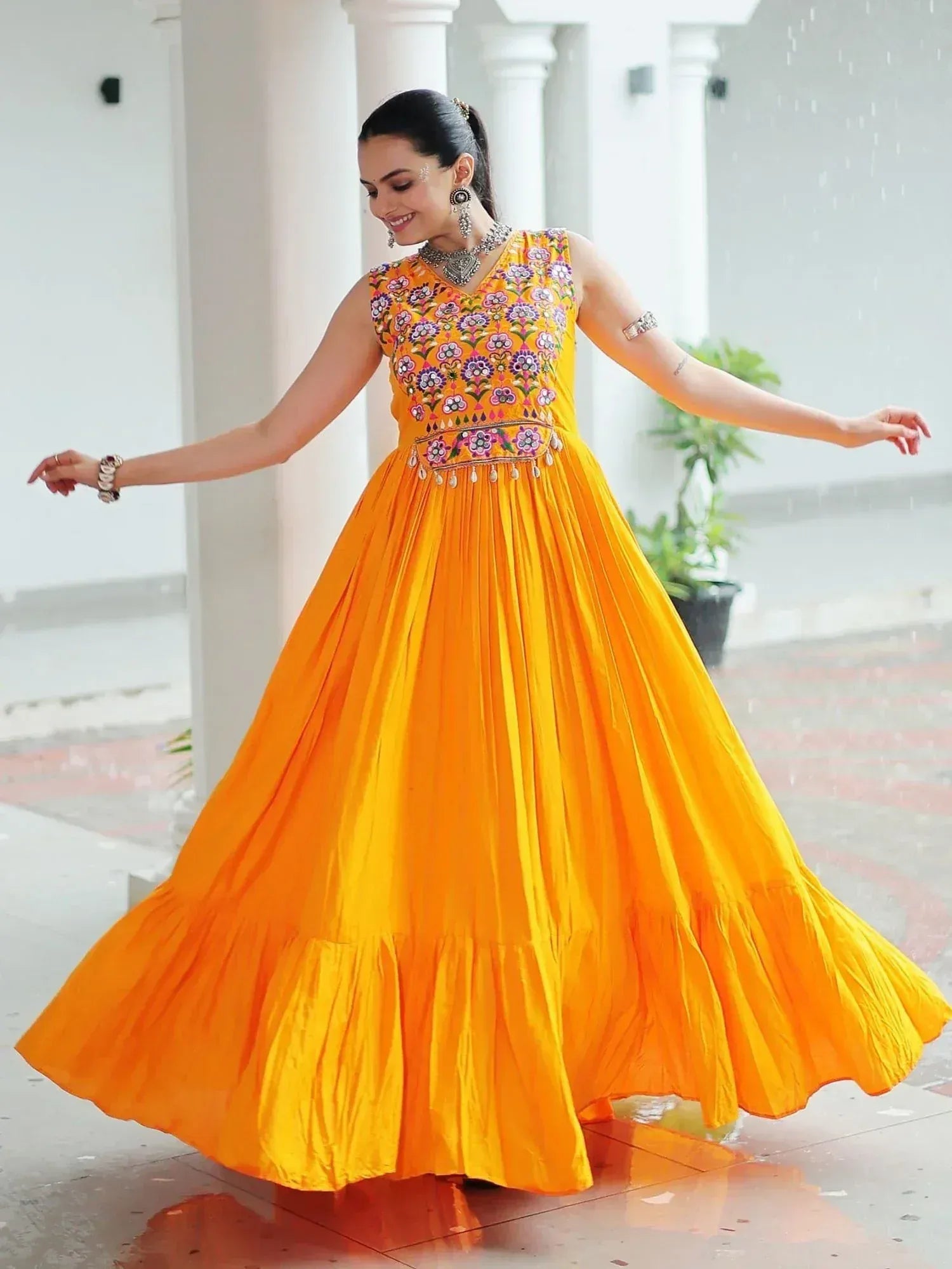 Vibrant yellow ethnic gown with floral embroidery, perfect for Indian festive occasions and celebrations.