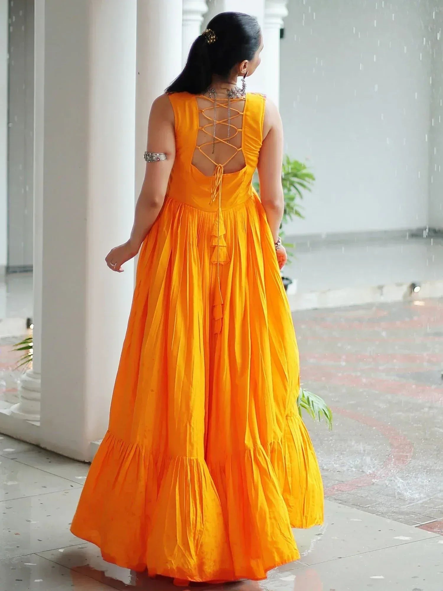 Vibrant orange ethnic gown with lace-up back, perfect for Indian festive occasions