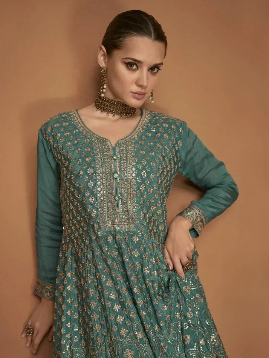 Teal embroidered ethnic gown with gold floral detailing, perfect for Indian festive occasions