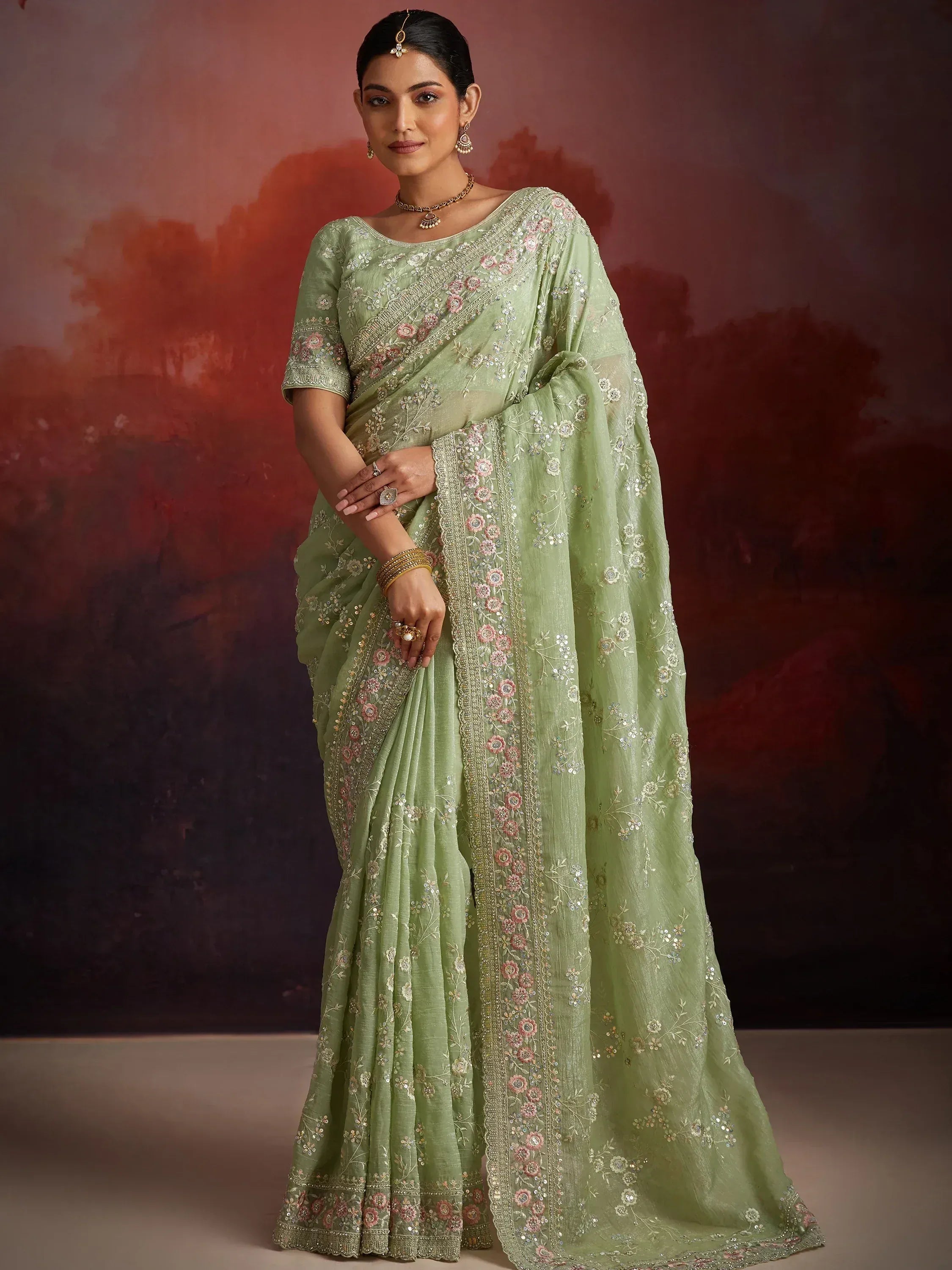 Light green embroidered saree with floral motifs and sequins, perfect for Indian ethnic wear occasions