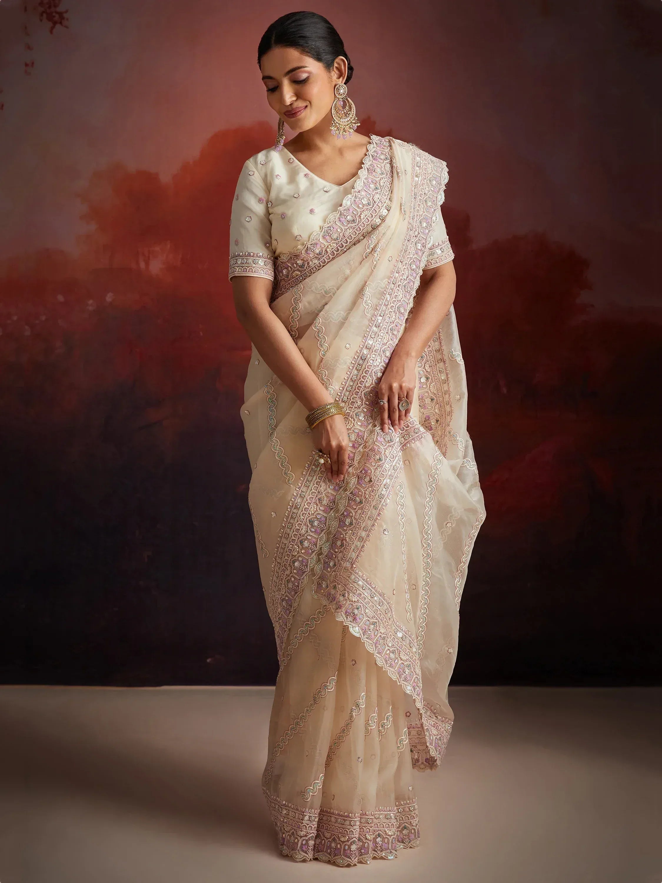 Elegant ivory saree with pink and gold embroidery, perfect for Indian ethnic wear occasions