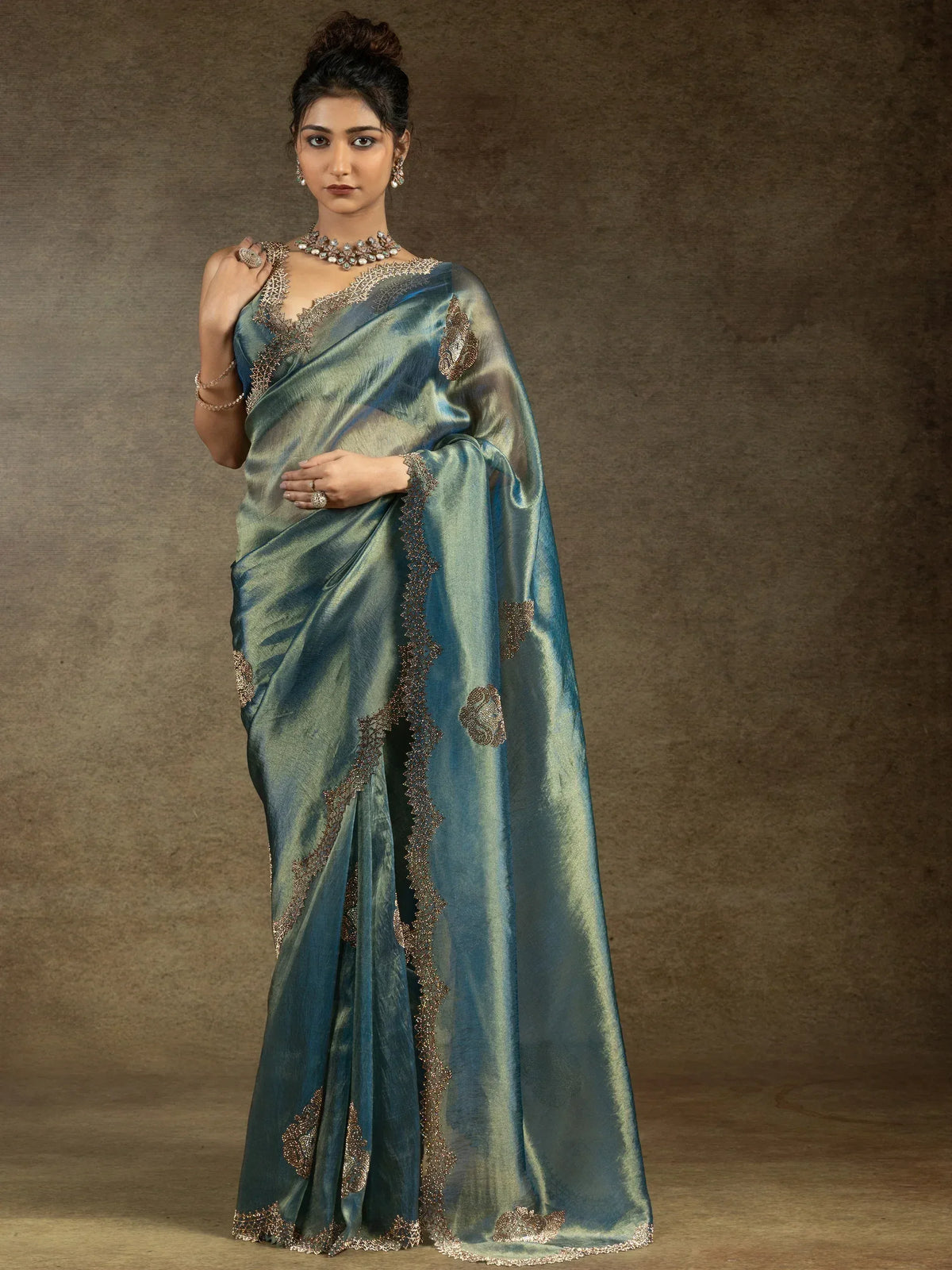 Elegant teal saree with gold embroidery, perfect for Indian ethnic wear occasions.