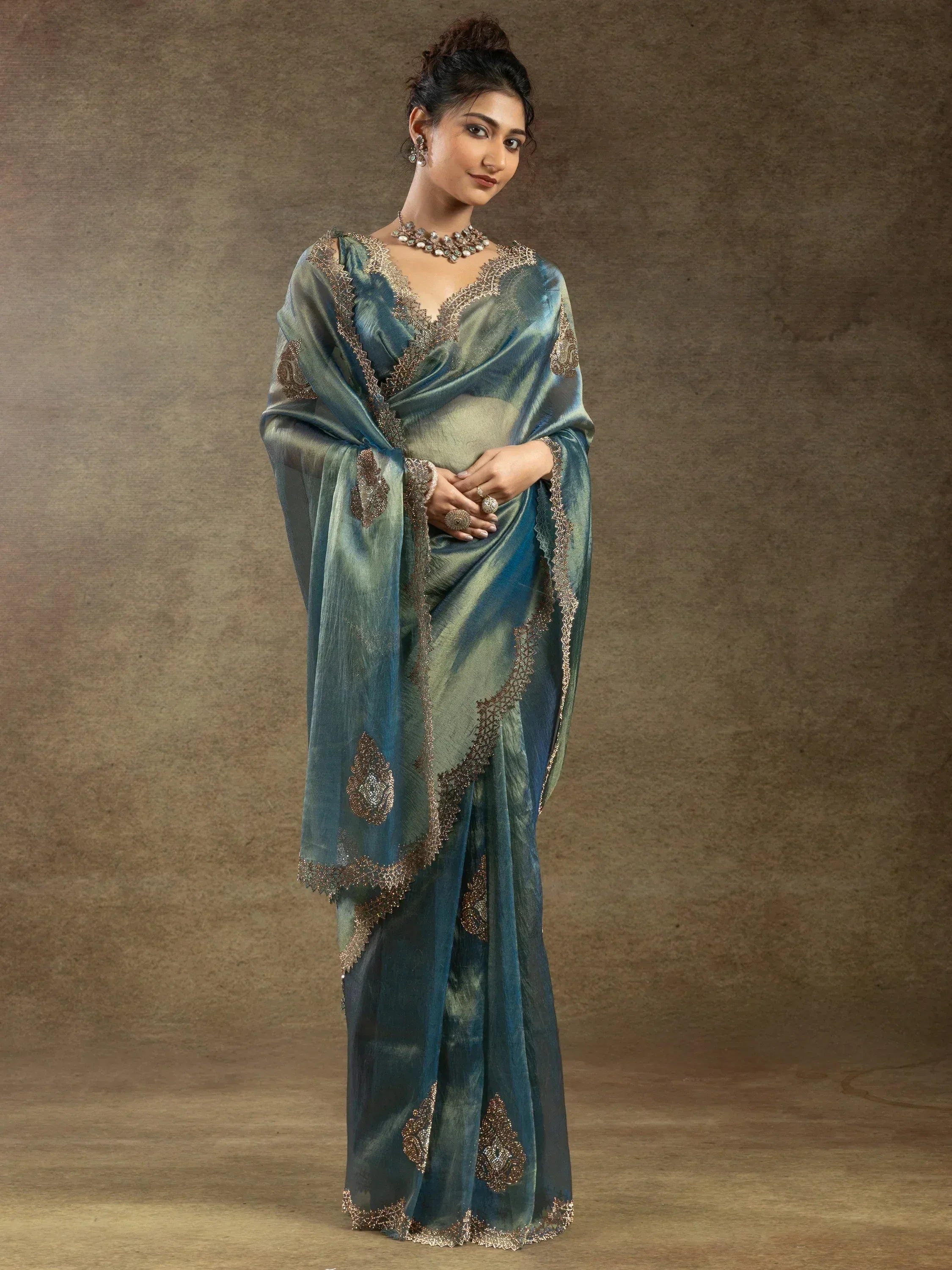 Elegant teal saree with gold embroidery, perfect for Indian ethnic wear occasions.