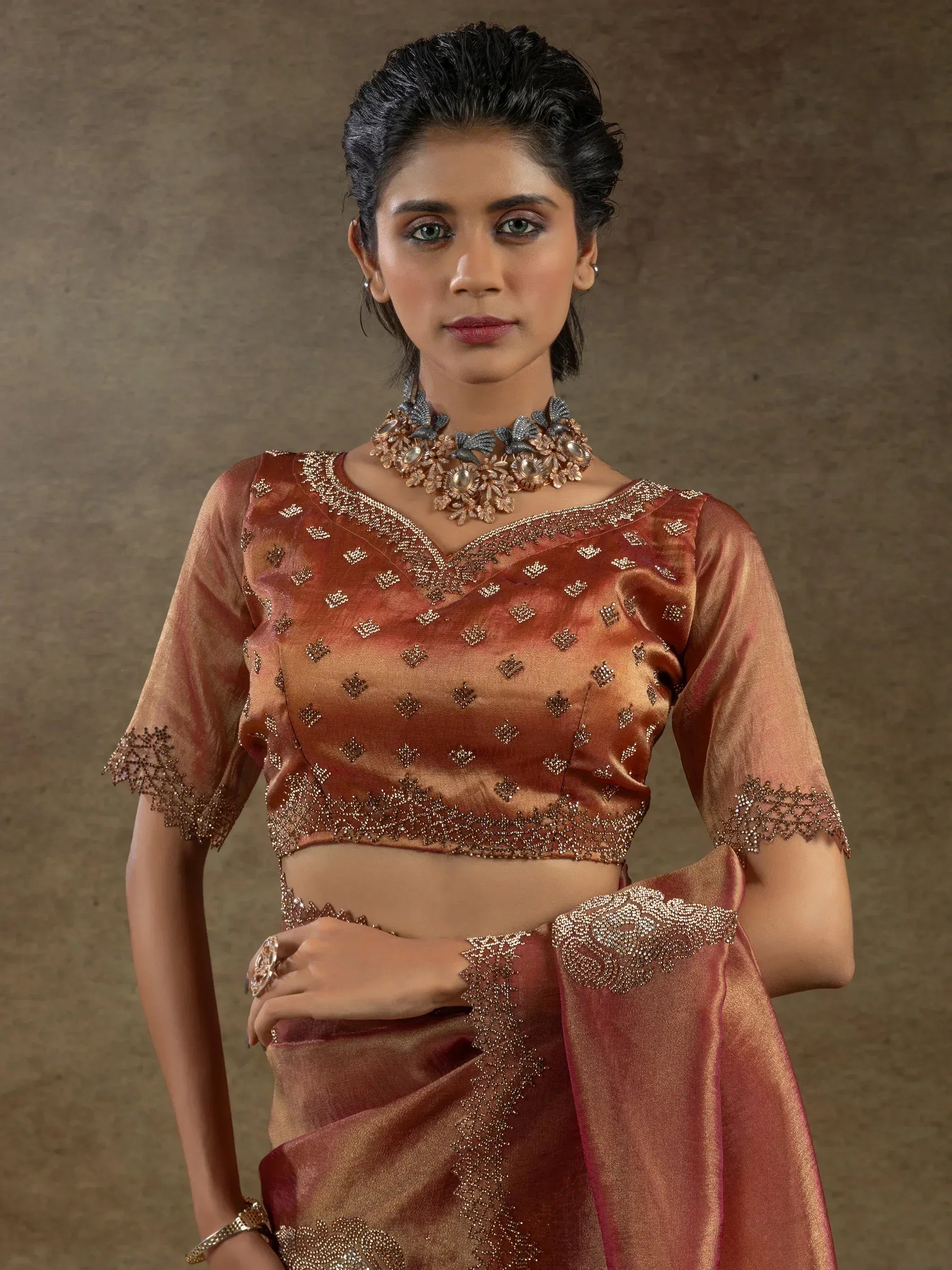 Elegant brown embroidered saree with matching blouse and floral necklace for ethnic wear