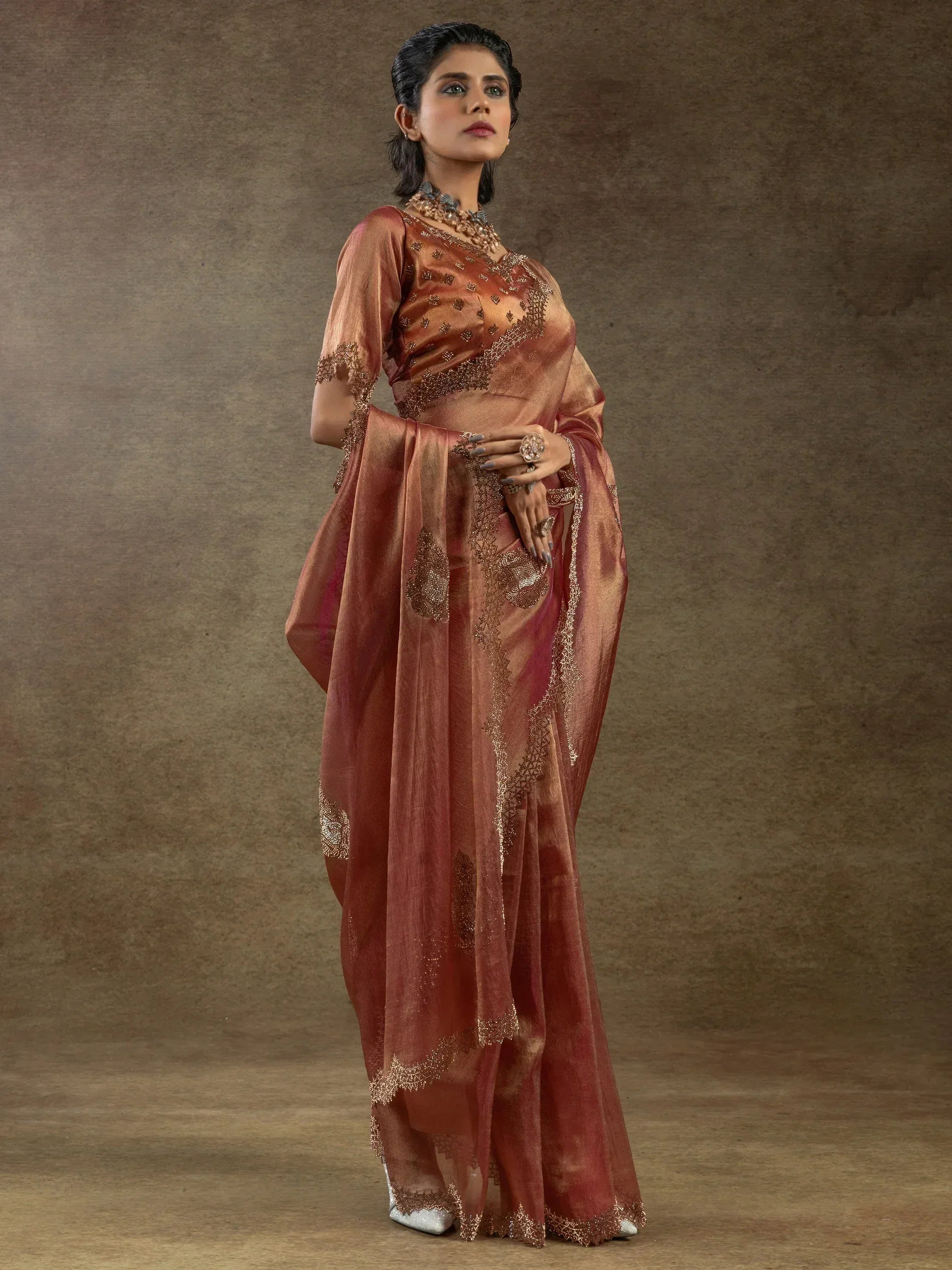 Elegant maroon saree with gold embroidery, perfect for Indian ethnic wear occasions.