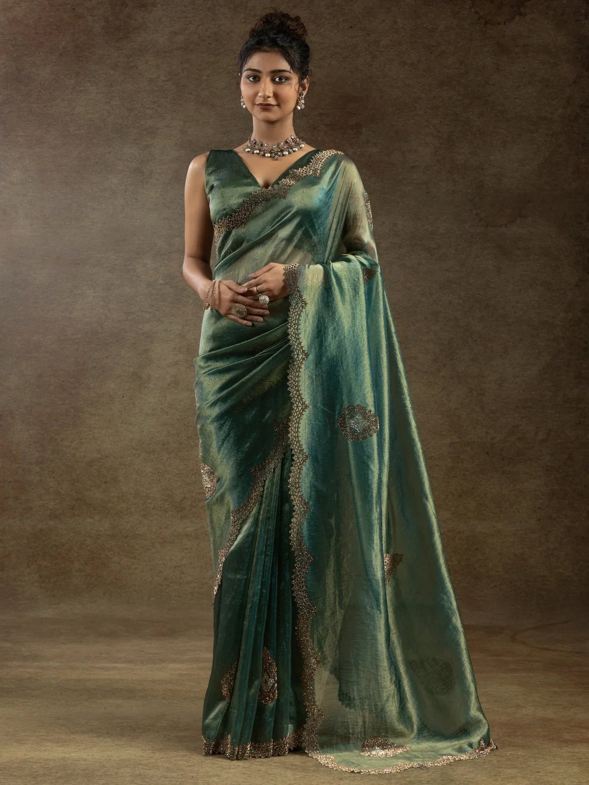Elegant green saree with gold embroidery, perfect for Indian ethnic wear occasions.