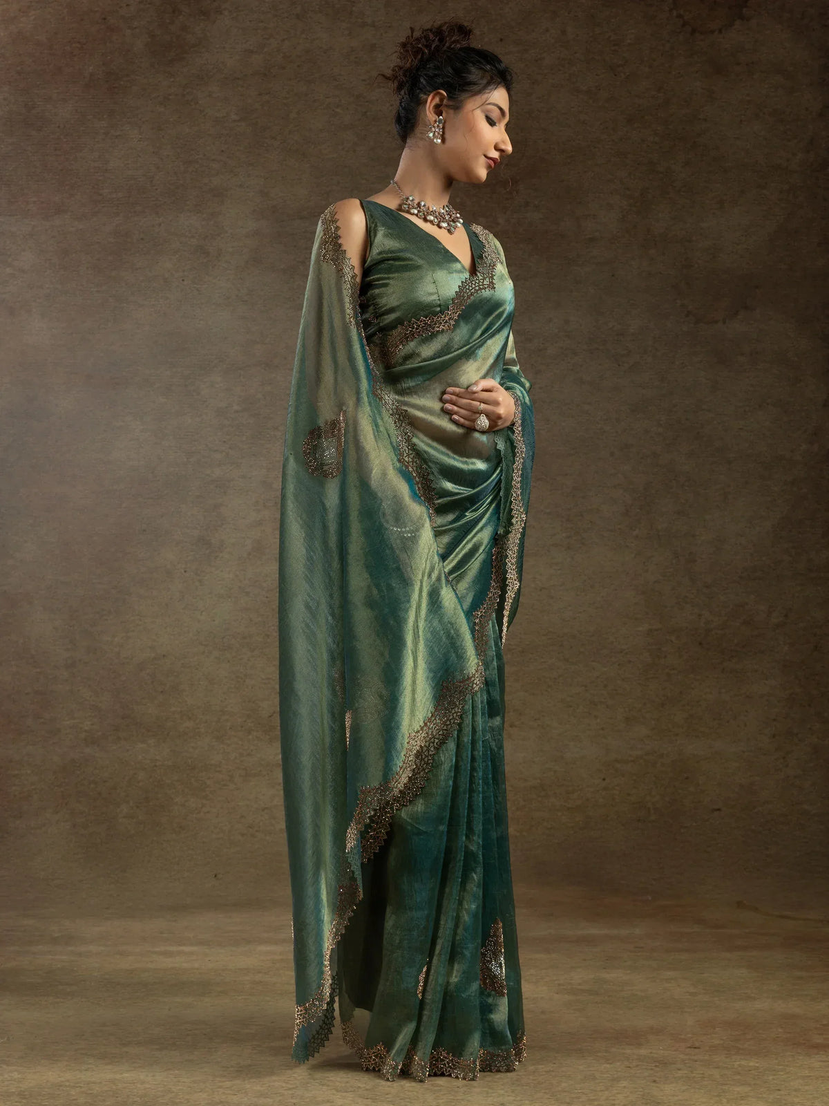 Elegant green saree with golden embroidery, perfect for Indian ethnic wear occasions.